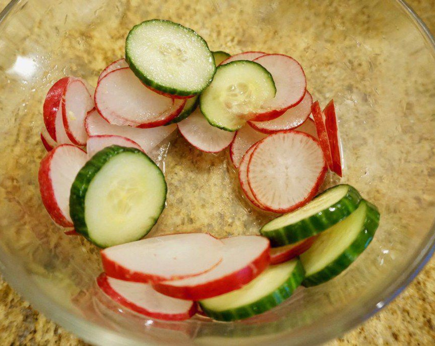 step 1 Combine Radish (1 bunch) and English Cucumber (1/2) in a bowl with the juice from Lemon (1), Granulated Sugar (1 tsp), and Sea Salt (1/2 tsp). Let sit while you prepare the rest of the salad to soak up the juices.