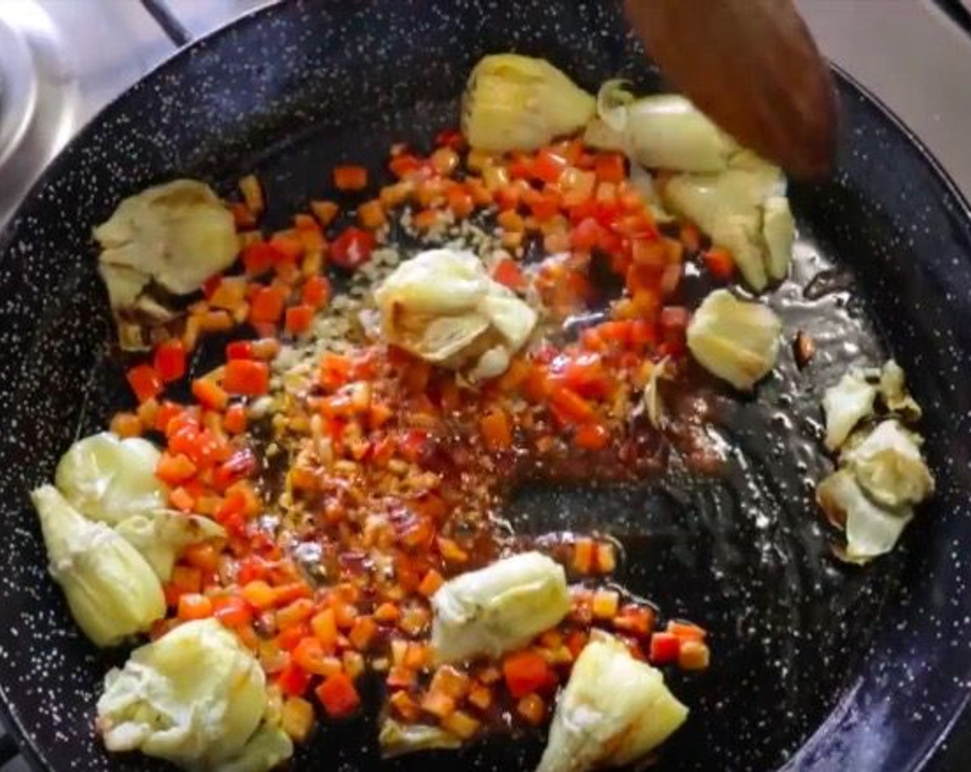 step 10 Make another well in the middle and add the Garlic (4 cloves). Cook for 30 seconds, then season with Smoked Paprika (1/2 tsp) and mix it all together.