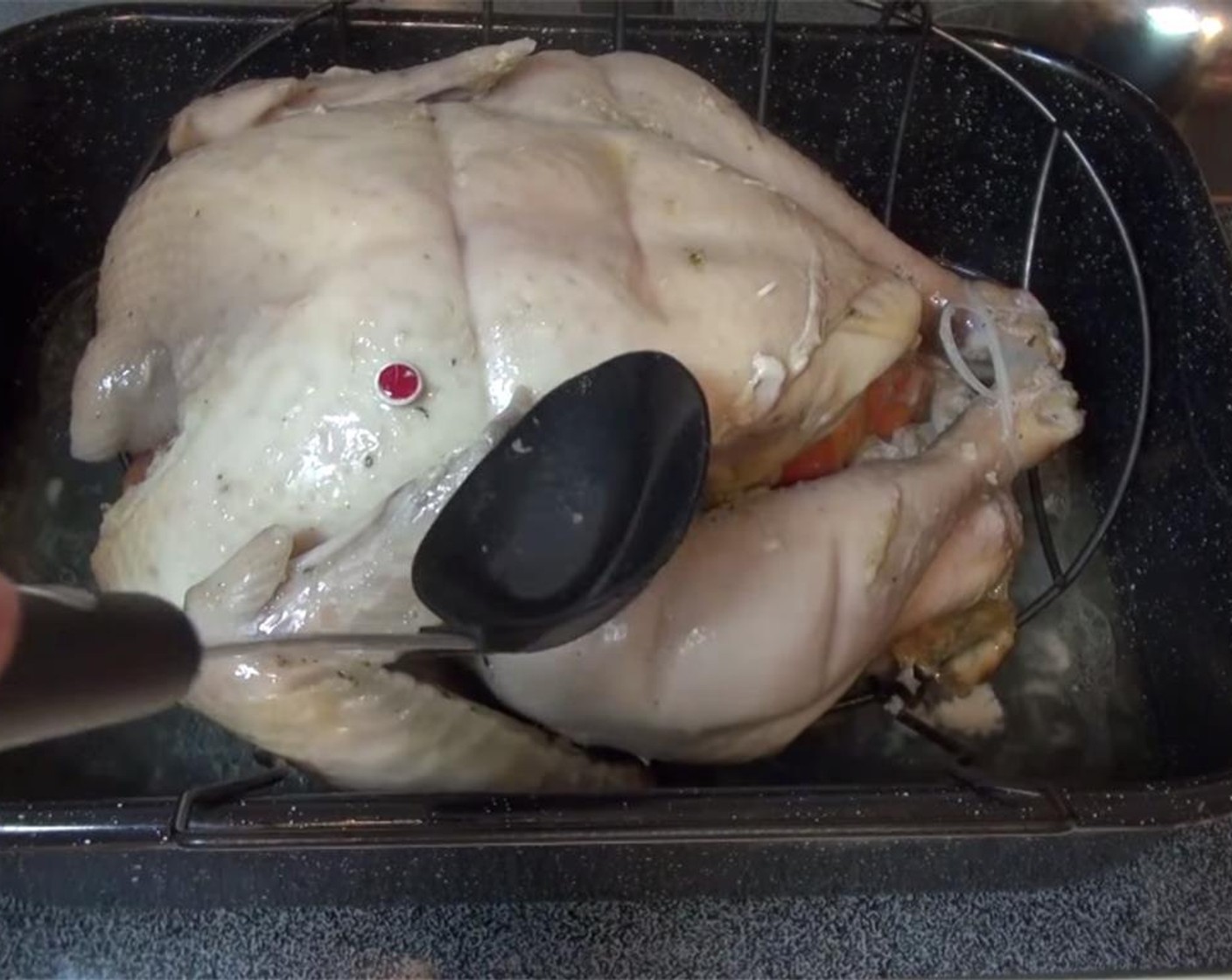 step 12 Remove pan from the oven, and flip over the turkey. I used several clean dish rags. Be very careful not to burn yourself. Baste the turkey with the liquid in the pan. Make sure to close the oven door after every time you remove the turkey.