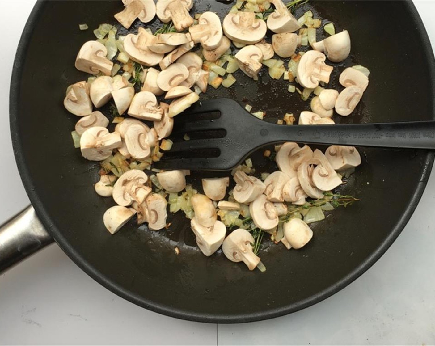 step 3 Cook them gently for 5 minutes until the onion is translucent. Stir regularly. Brush and clean the White Mushrooms (10) and chop them into bite-size chunks. Add them to the pan.