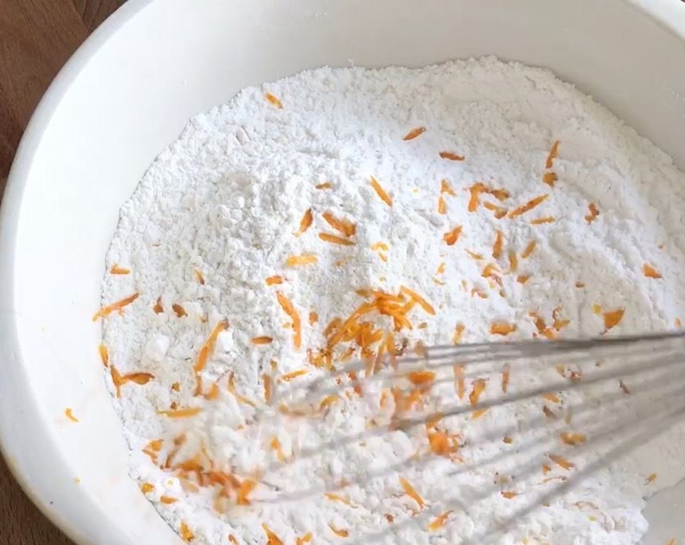 step 5 Meanwhile, prepare the dry ingredients. Sift the Hong Kong Flour (5 3/4 cups), Tapioca Starch (1/3 cup), and Baking Powder (1/2 Tbsp) into another mixing bowl. Mix in orange zest and set aside.