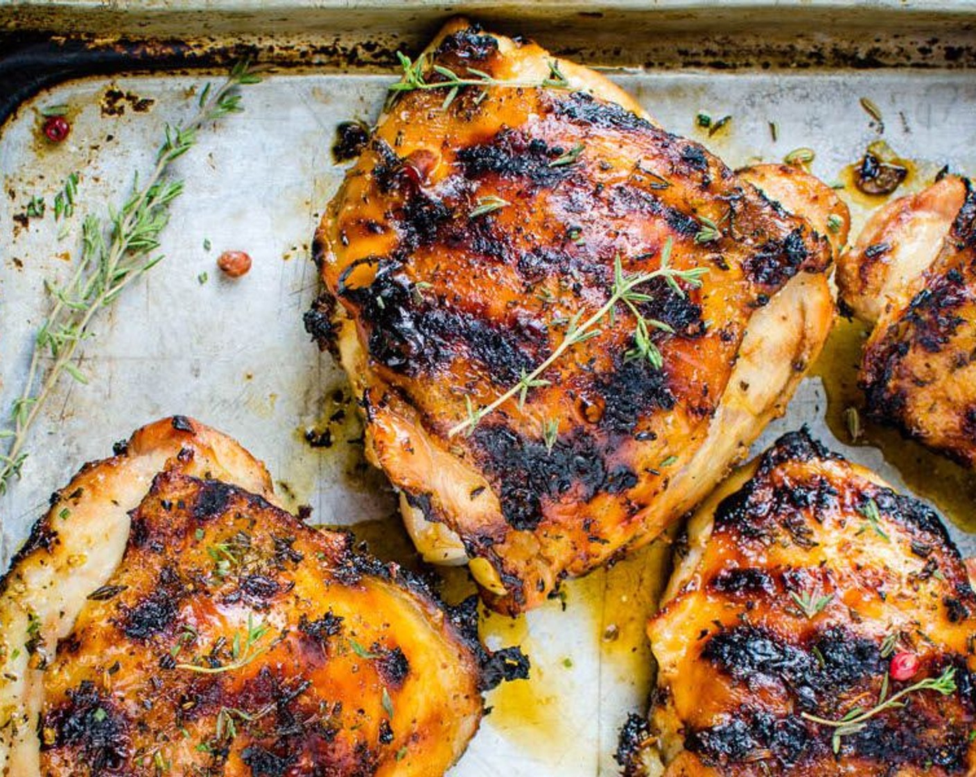 step 5 To grill, place thighs skin side down on the 375 degrees F (190 degrees C) grill for 6 minutes. Turn chicken, and continue cooking for approximately 12 minutes. For roasting, set a rack over a rimmed baking sheet. Place chicken on rack in the oven at 450 degrees F (230 degrees C). Roast 25-30 minutes, until skin is crispy and browned and flesh is cooked through, but still juicy.