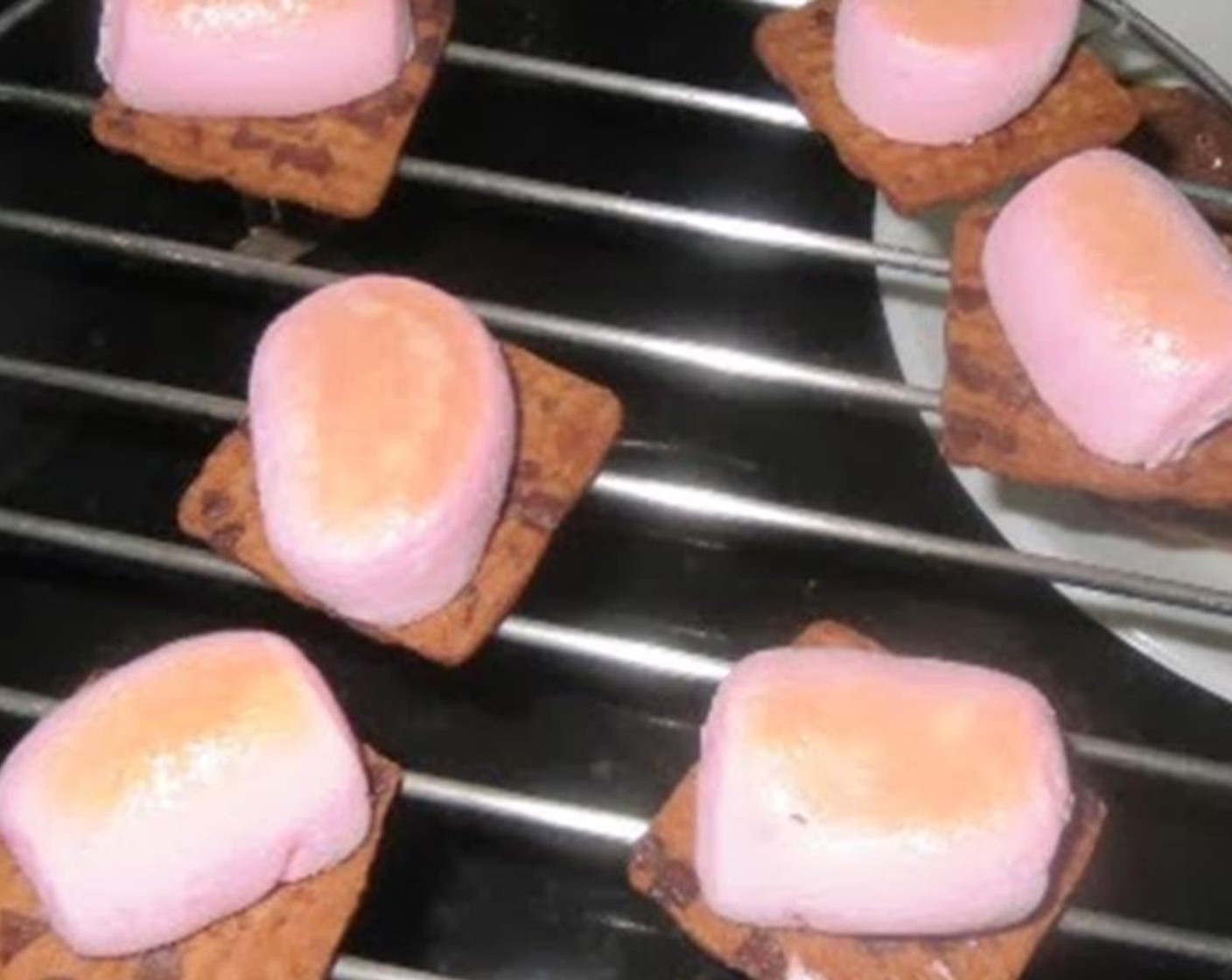 step 2 Place the crackers on the baking pan. Place it under the broiler for 3 to 4 minutes at 360 degrees F (180 degrees C) or until the marshmallow are brown and roasted.