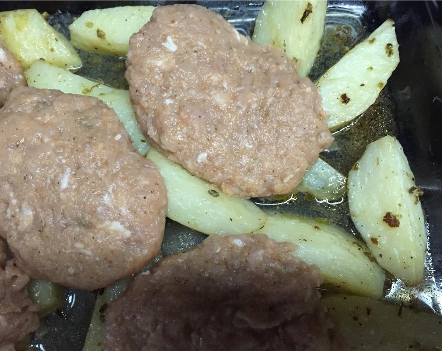 step 7 When the hour has passed remove the potatoes from the oven. Remove the foil and place the burger patties on top of them. Return the tray to the oven and bake for about 45 minutes.