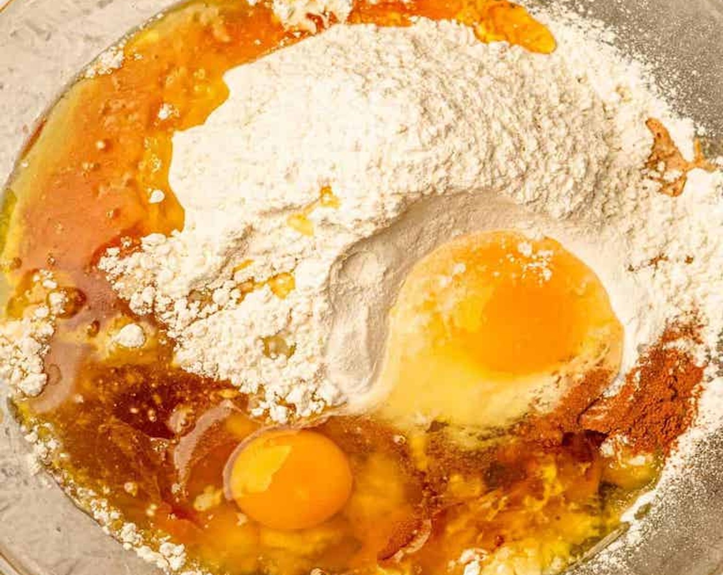 step 2 Combine Bananas (2), All-Purpose Flour (1 1/2 cups), Baking Soda (1 tsp), Simply Organic Cinnamon, Ground (1 tsp), Salt (1/2 tsp), Vanilla Extract (1 tsp), Eggland's Best Classic Eggs (2), Maple Syrup (1/2 cup), and Olive Oil (3 Tbsp) in a large bowl and mix to combine until smooth.