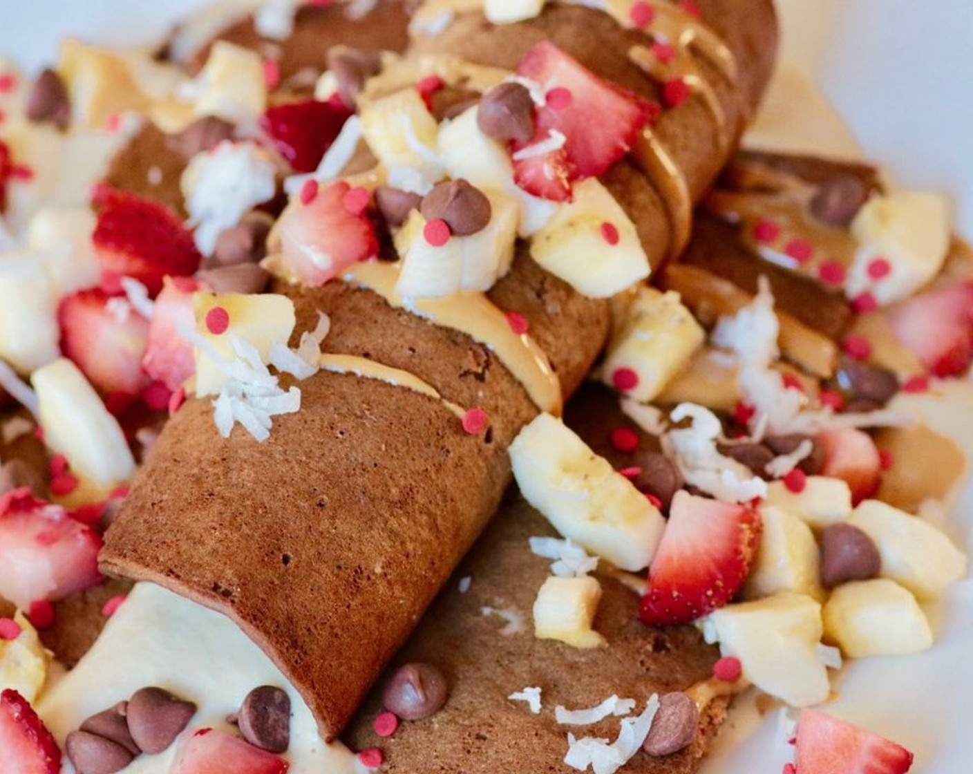 step 8 Serve. Optionally you can top with drizzled peanut butter, and then strawberries, bananas, red sprinkles, vegan chocolate chips, and shredded coconut.