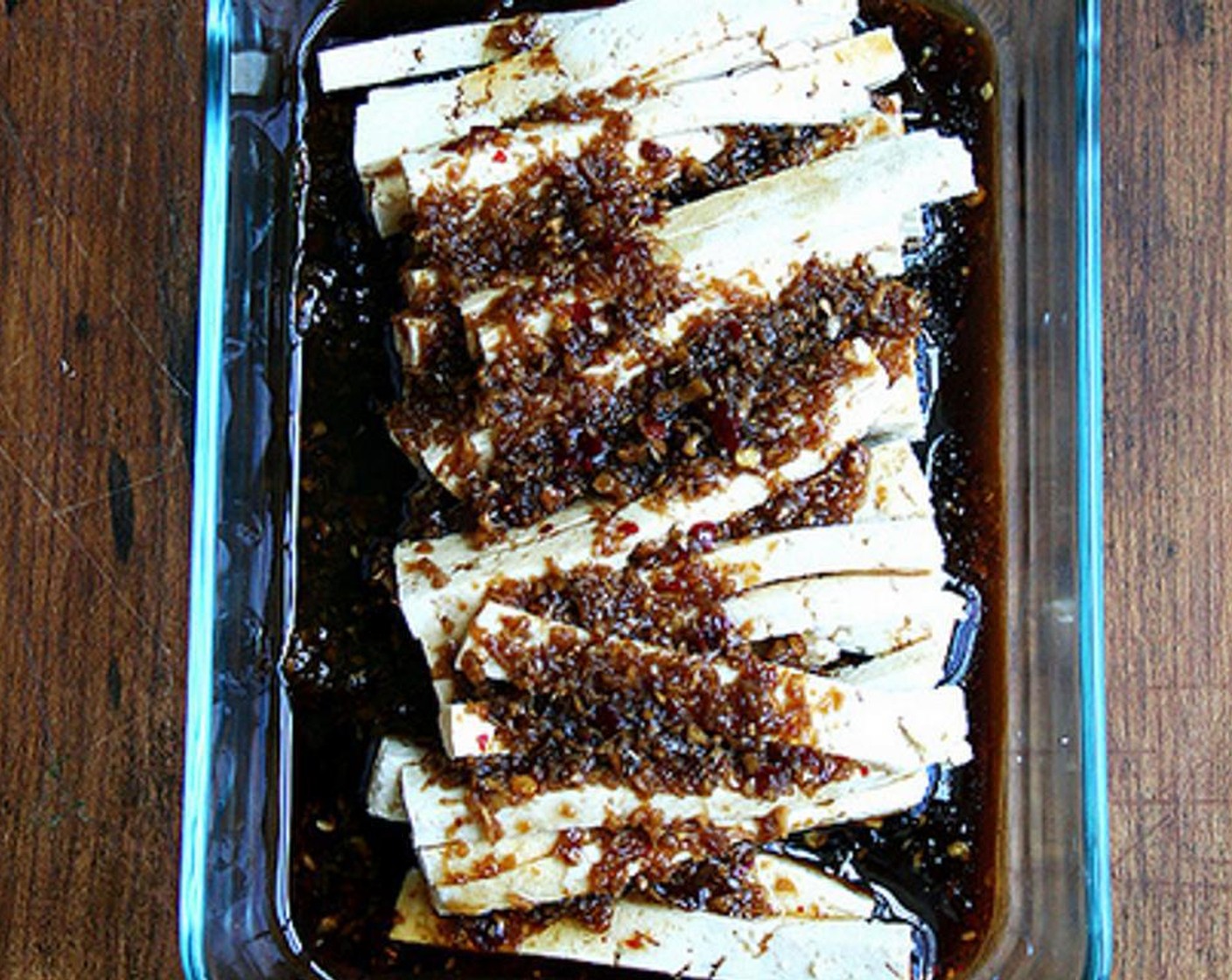 step 6 Place tofu slices in flat-bottomed vessel. Pour marinade overtop to submerge. Let sit for at least an hour and for as long as overnight.