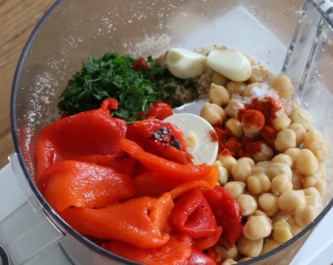 step 4 Add Roasted Red Peppers (1 jar) to the food processor or blender, reserving the liquid left behind in the jar, along with the Chickpeas (1 can), Garlic (2 cloves), Fresh Parsley (2 Tbsp), Sherry Vinegar (2 Tbsp), Smoked Paprika (1/4 tsp), Kosher Salt (1 tsp), and 3 Tbsp of liquid from the jar of peppers. Use less if you've already added some.
