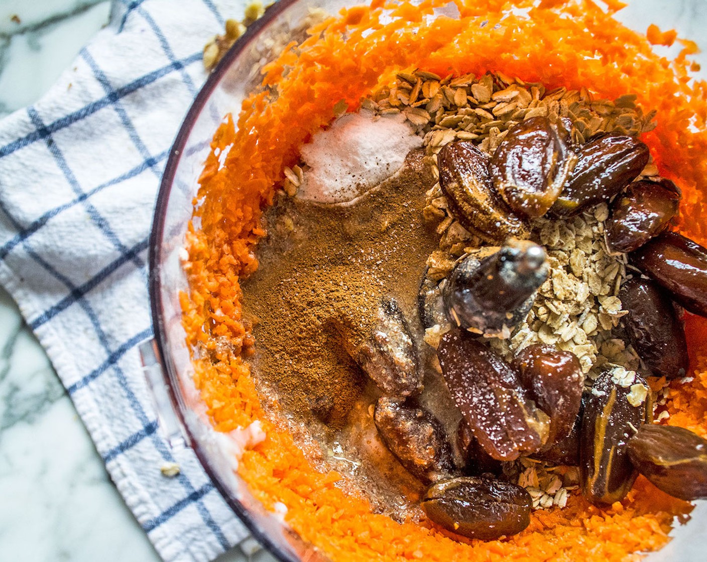 step 4 Add Gluten-Free Rolled Oats (1 1/2 cups), Chickpea Flour (1/3 cup), Medjool Dates (3/4 cup), Refined Coconut Oil (1/4 cup), Apple Sauce (1/4 cup), Pure Maple Syrup (1/4 cup), flax eggs, Distilled White Vinegar (1 Tbsp), Baking Soda (1 tsp), Ground Cinnamon (1 tsp), and Salt (1 pinch). Process another 20 seconds or until all ingredients are well combined.