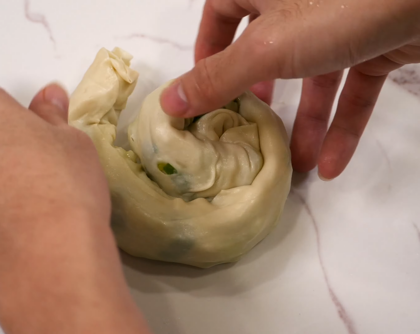 step 9 Roll the dough into a log, then roll the log into a ball, making sure that the ends are well tucked under. Lightly press the dough down and set it aside.