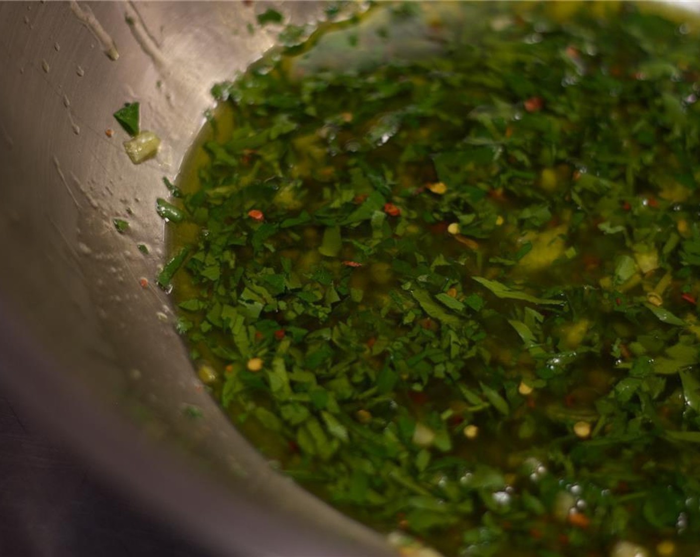step 5 Combine the Capers (2 Tbsp), parsley, oregano, lemon peel, Crushed Red Pepper Flakes (1/2 tsp), Extra-Virgin Olive Oil (1 cup), and the juice from Lemon (1) in a mixing bowl and stir together.