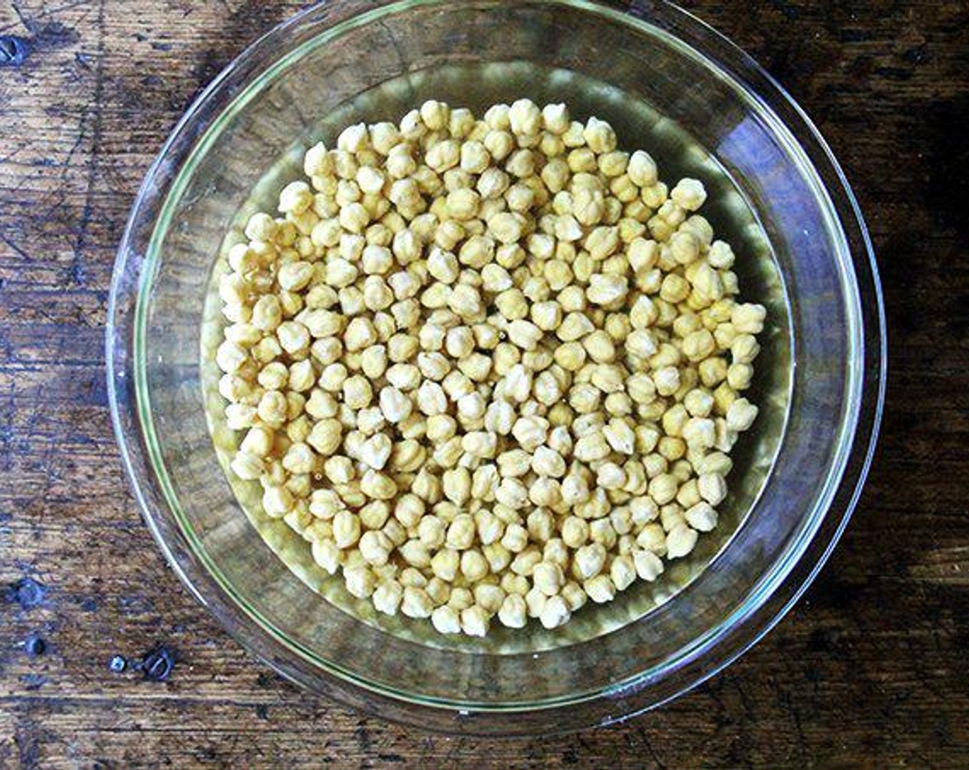 step 1 Place the Dried Chickpeas (2 1/4 cups) in a large bowl and cover with water by at least 3 inches. Add the Kosher Salt (3 Tbsp) and stir to dissolve. Let sit at room temperature overnight or for 8-10 hours at least.