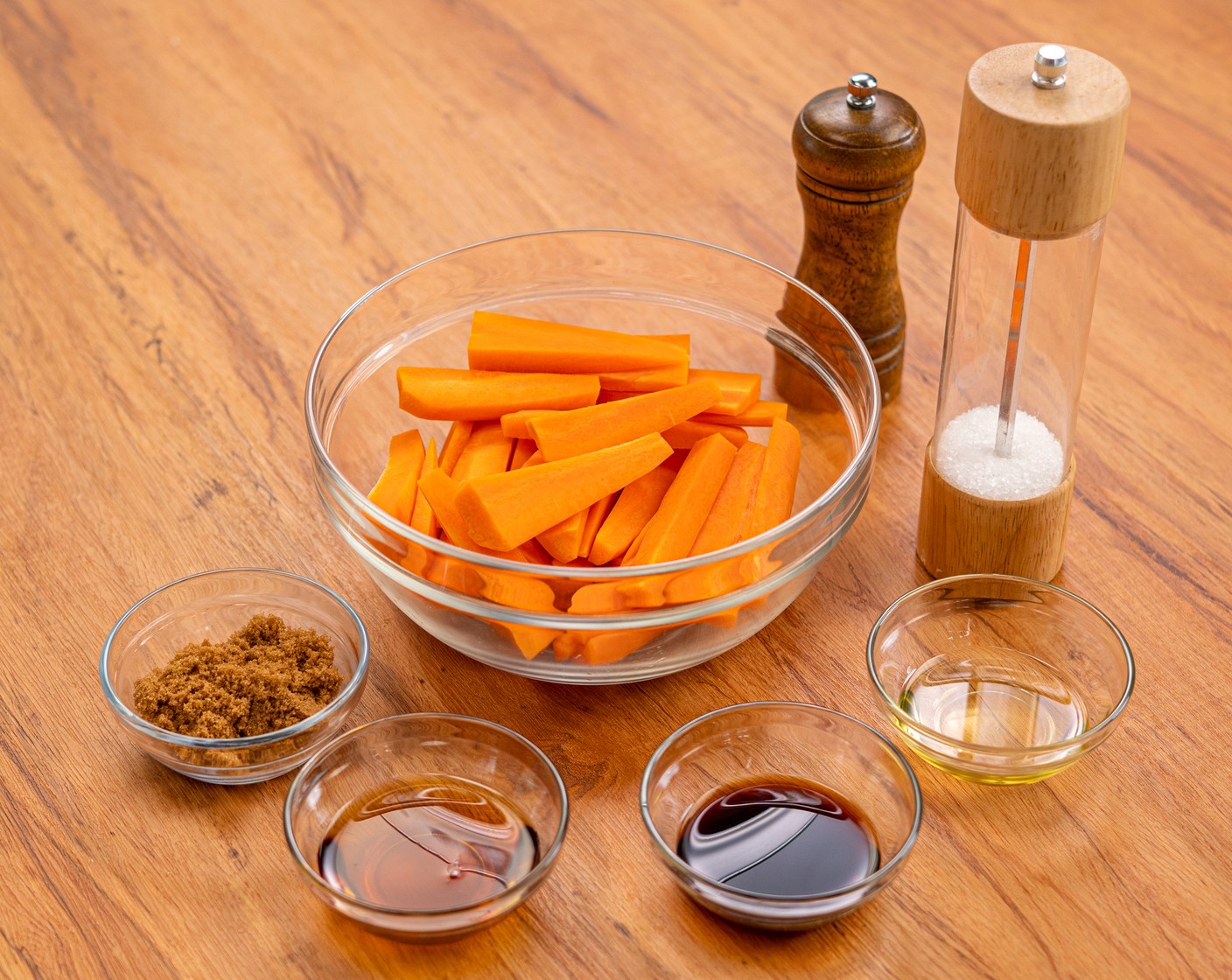 step 2 In a large mixing bowl, add the carrots along with Brown Sugar (2 Tbsp), Maple Syrup (2 Tbsp), Balsamic Vinegar (1 Tbsp), Olive Oil (1 Tbsp), Salt (1/4 tsp), and Ground Black Pepper (1/4 tsp). Toss until combined.