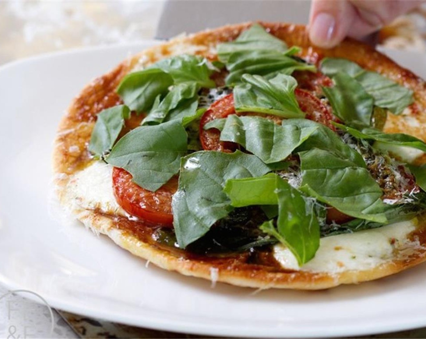 step 5 Remove pizzas from the pan, and serve with additional basil, parmesan, and Balsamic Vinegar (to taste).