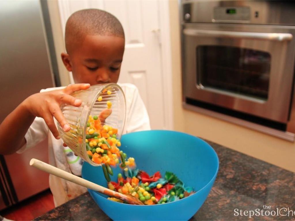 Step 7 of Rainbow Pasta Salad Recipe: In a large bowl, toss cooled pasta and mixed veggies. Add Ground Black Pepper (to taste), Olive Oil (3 tablespoon), Salt (to taste), and Italian Dressing (1/4 cup) to the bowl.