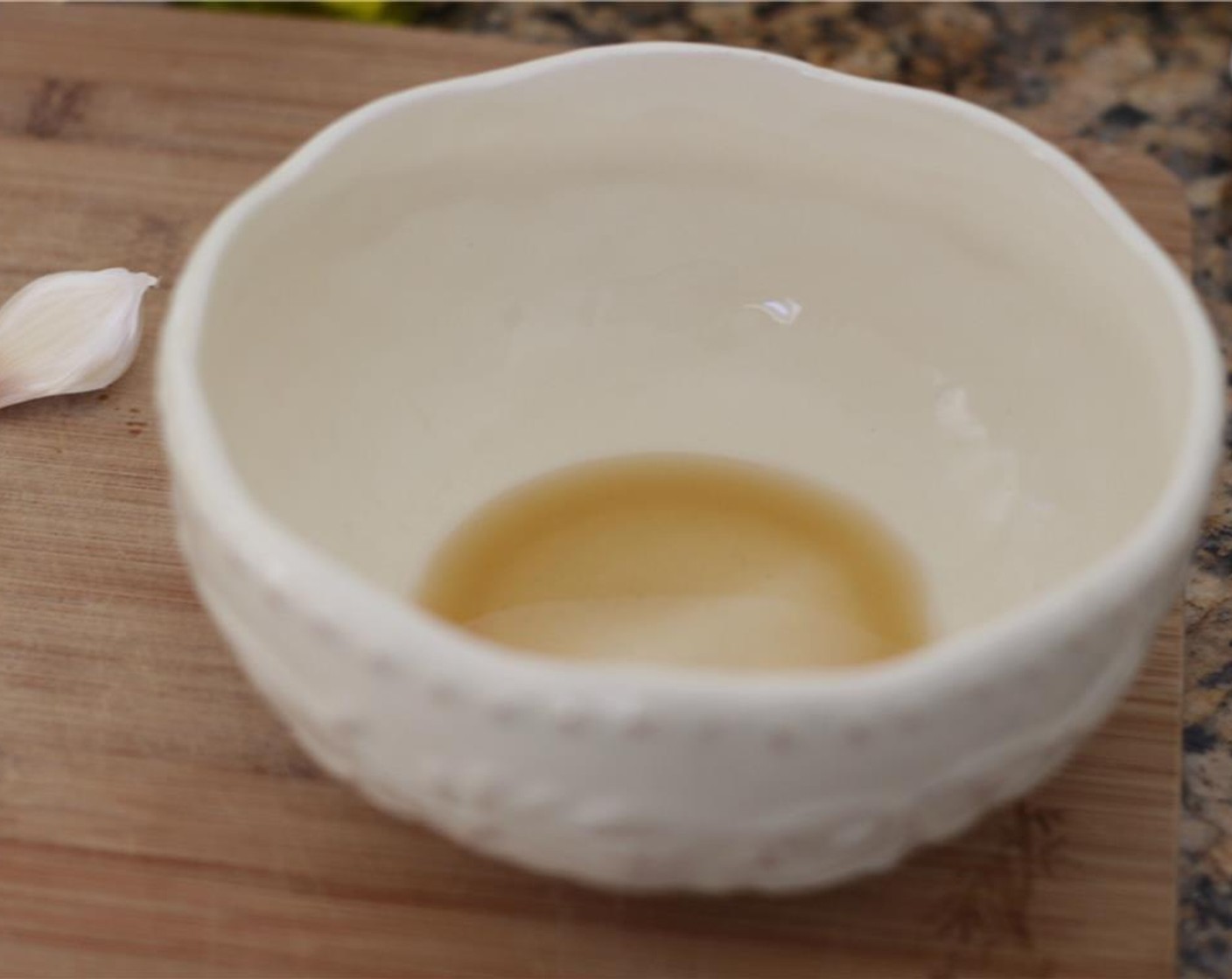 step 8 Pour the remaining sage-infused oil into a small bowl. Finely mince or grate the Garlic (1 clove) and put it in the bowl.