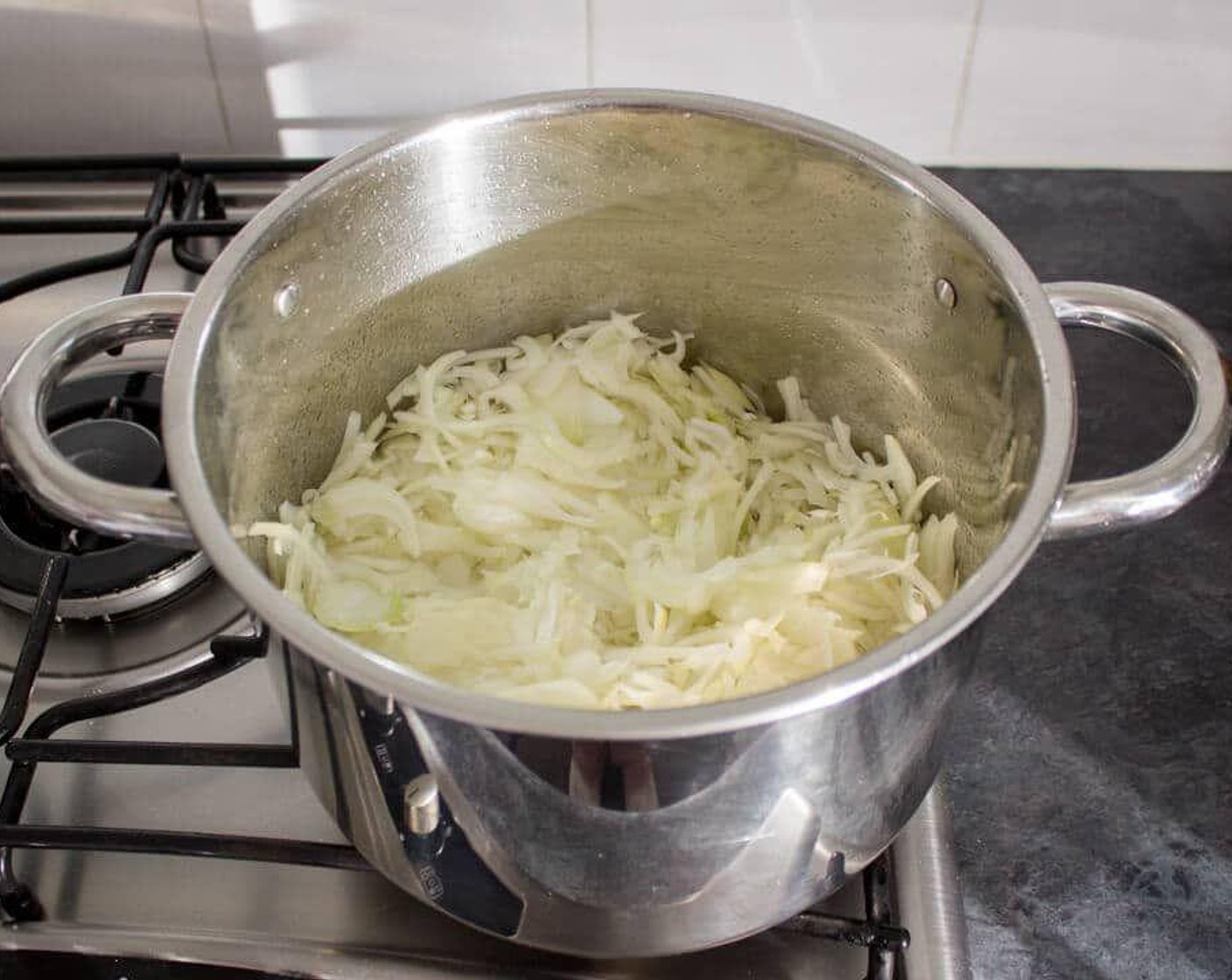step 1 Take your large pot and place over a medium heat. Add in the Butter (3 Tbsp). When melted, tip in all the Onions (5 cups) and give it a stir.