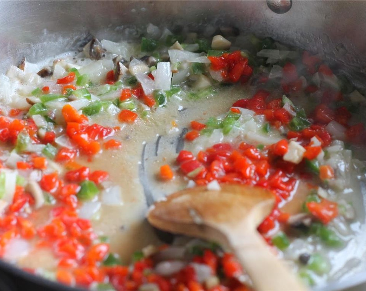 step 8 In an extra-large skillet or stockpot, melt Butter (1/2 cup) and add Onion (1 cup), Mushroom (1 cup), Green Bell Pepper (1/2 cup), and Pimiento Pepper (1 jar). Stir and sauté until all vegetables are tender.