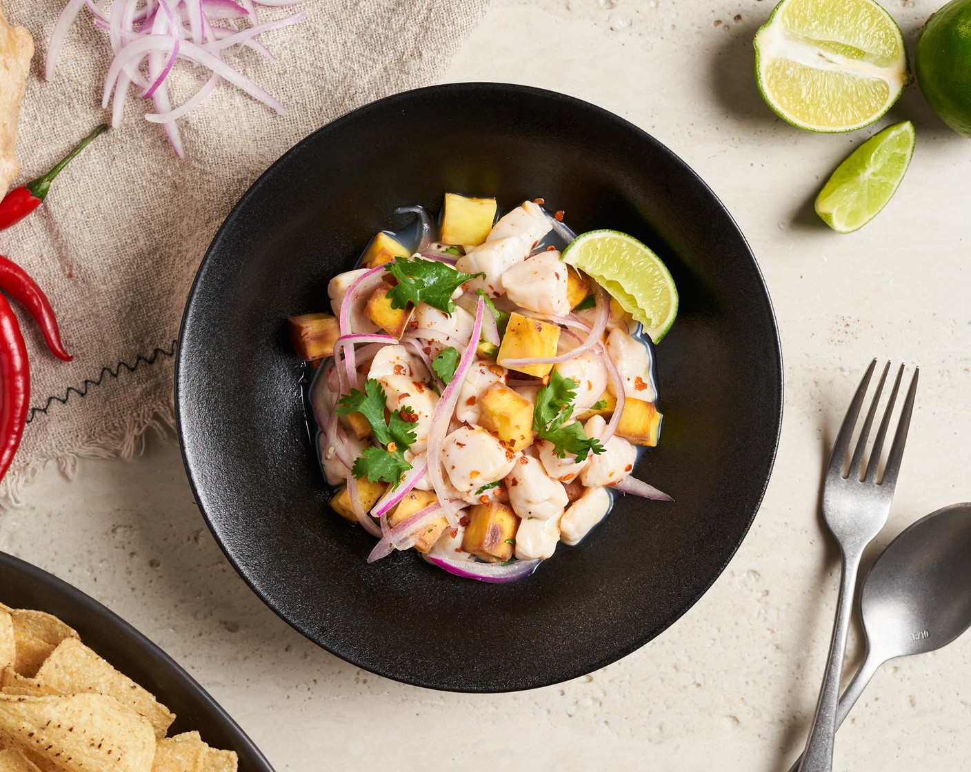 step 6 Serve the scallop ceviche in a bowl with some of the ceviche liquid, garnished with coriander leaves. Serve with Tortilla Chips (1 cup) on the side.