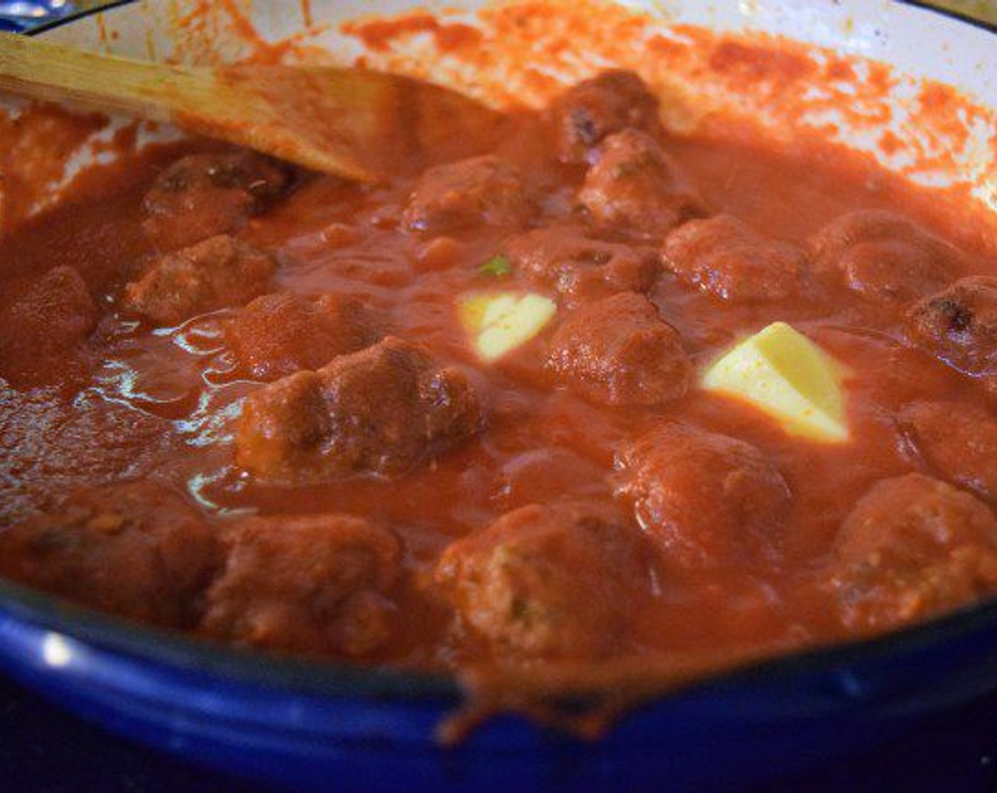 step 9 Then, add crushed garlic, Tomato Sauce (2 3/4 cups), and Fresh Basil Leaves (2) and season with salt and pepper. Add the meatballs back to the sauce along with 2 tbsp of butter. Taste and season with salt and pepper as desired. Simmer the meatballs in the sauce for about 15 minutes.