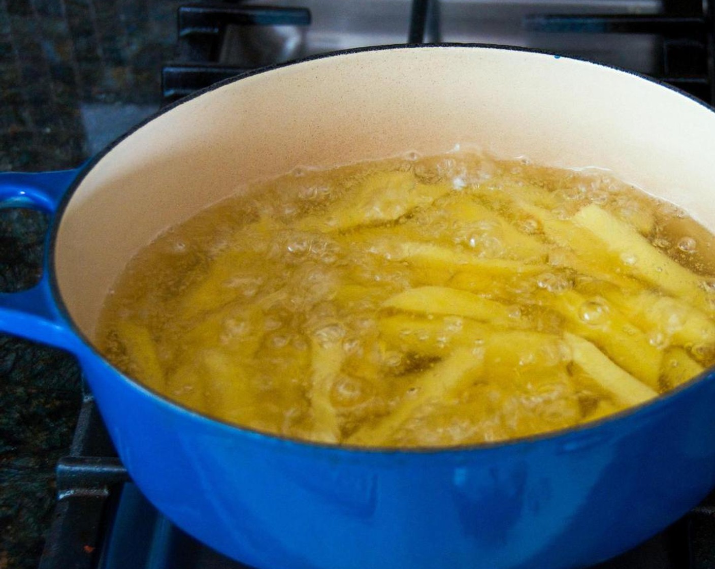 step 5 Place the oven on the stove and turn the heat to medium-medium high. The oil will bubble briskly once it comes to temperature.