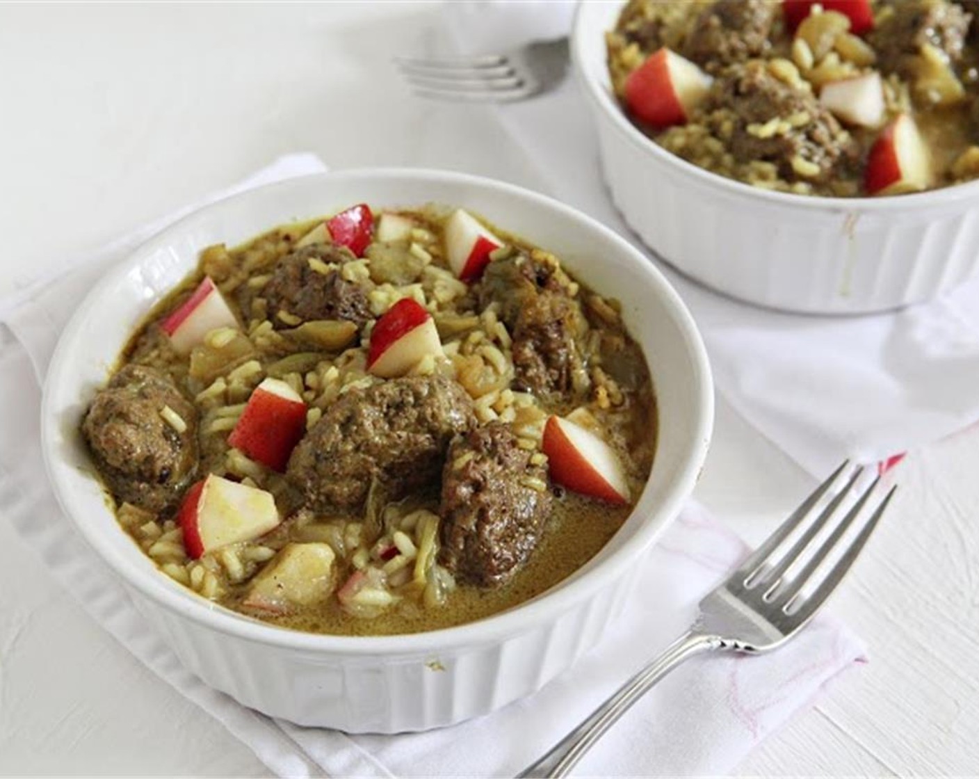 step 9 Dice the Red Pears (2). Divide rice in two bowls, ladle curried guinea meatballs over rice, and top with diced red pears. Enjoy!