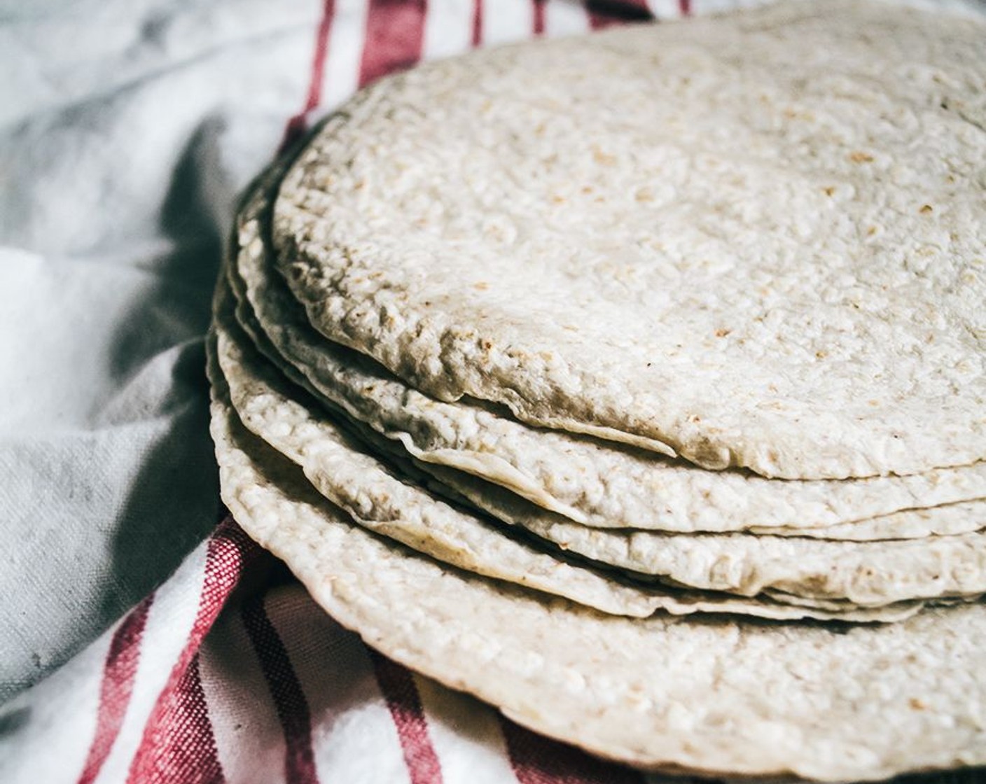 step 7 Lay out Whole Wheat Tortillas (10) and add two large spoonfuls of butternut squash mix to center of each tortilla. Sprinkle with a layer of lite Shredded Mexican Cheese Blend (1 cup) then fold two ends in and add to casserole dish with the folded side down.