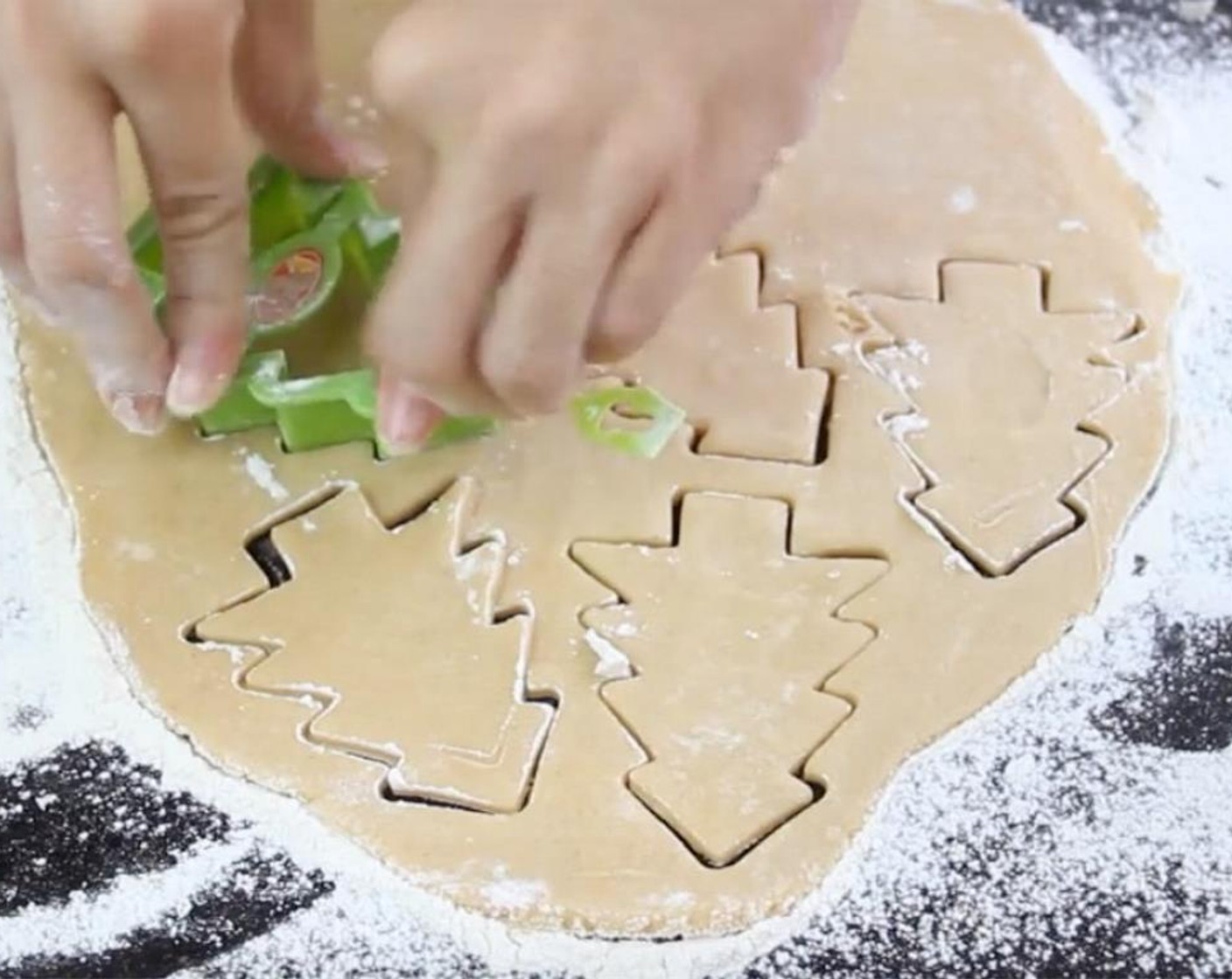 step 7 Cut out shapes using a Christmas tree cutter that has been coated with flour. Re-roll if needed to repeat.