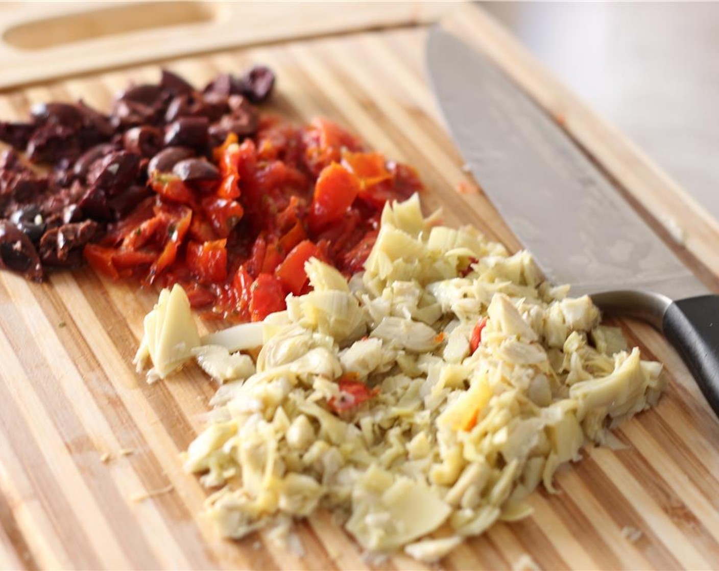 step 2 Chop the Roasted Tomatoes (1/2 cup), Kalamata Olives (12), and Marinated Artichokes (1/2 cup).