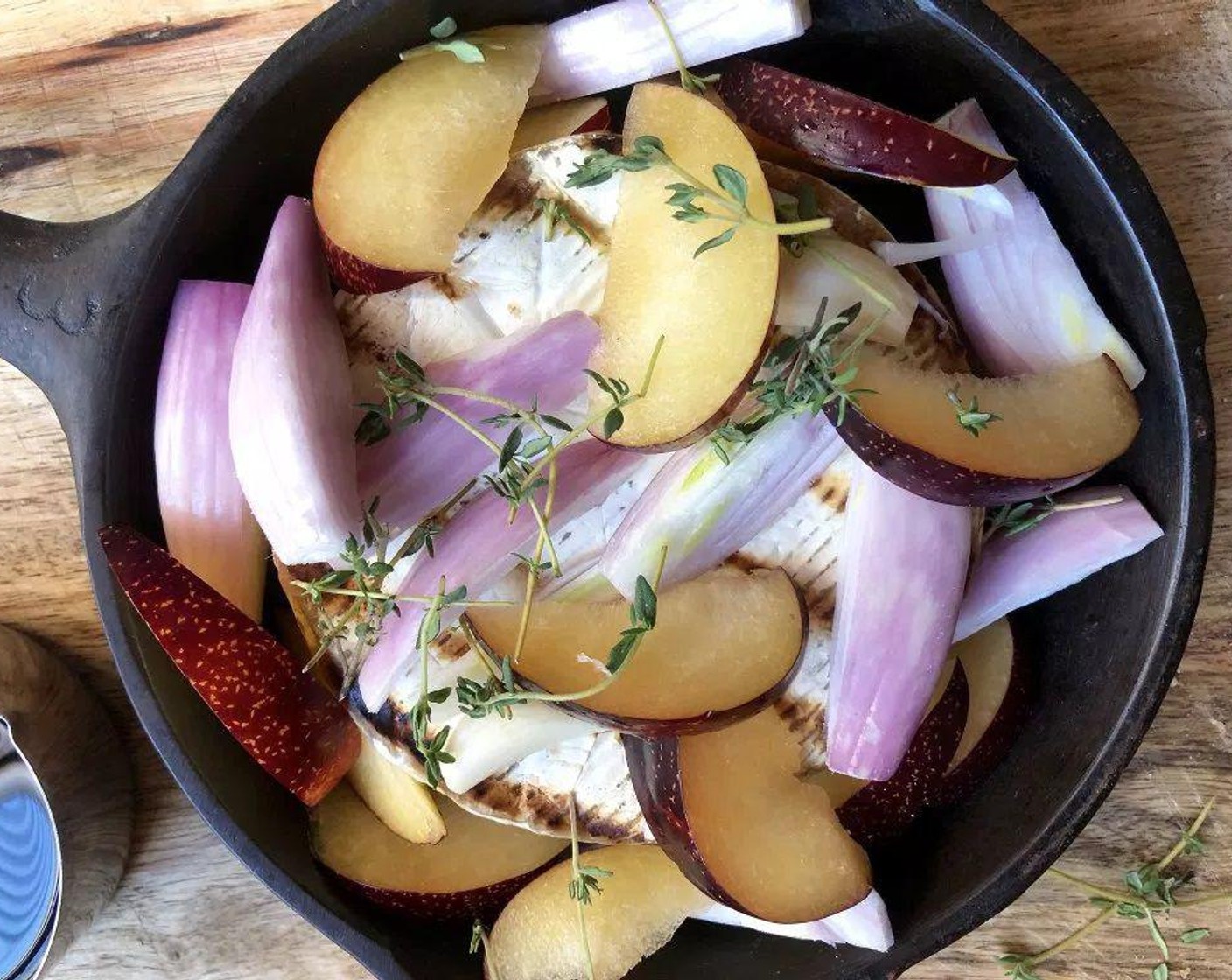 step 3 Carefully transfer Brie to round cast-iron pan or ovenproof dish. Top with Plum (1), Shallot (1), Garlic (1 clove), and Fresh Thyme (4 sprigs). Drizzle the Extra-Virgin Olive Oil (2 Tbsp) and Aged Balsamic Vinegar (2 Tbsp) evenly over the top. Season with Coarse Kosher Salt (1/2 tsp) and Ground Black Pepper (1/2 tsp).