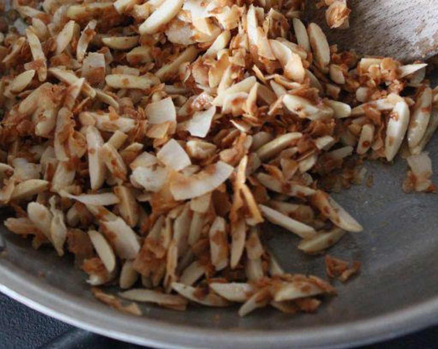 step 2 In a medium (10-inch) sauté pan, toast the Blanched Slivered Almonds (1/2 cup) and Unsweetened Coconut Flakes (1/2 cup) over medium-low heat, stirring occasionally, until the coconut begins to brown. Begin stirring almost constantly and continue to cook until the coconut is golden brown, about 10 minutes total.