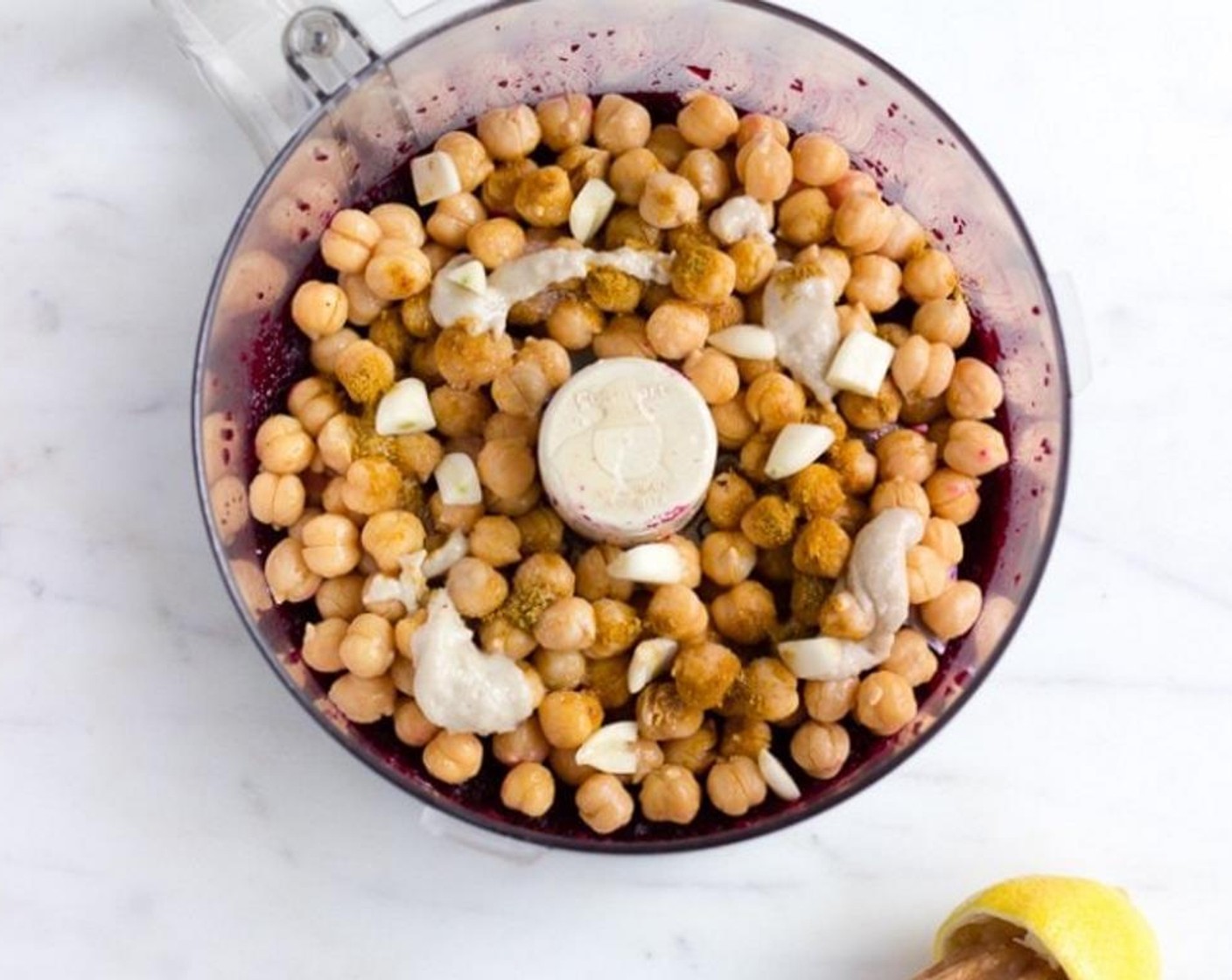 step 5 Once beets are well chopped, add the chickpeas, Garlic (2 cloves), juice from the Lemon (1/2), Ground Cumin (1 tsp), Fine Salt (1/2 tsp) and Tahini (1 Tbsp) to the food processor bowl and process until well combined, stopping to scrape the sides as needed.