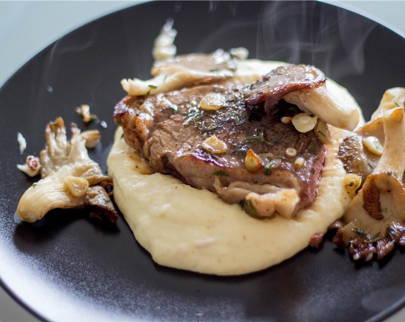 step 6 Serve the parsnip puree in the center of the plate, place the beef tenderloin steaks on top and the chanterelle mushrooms around the plate.