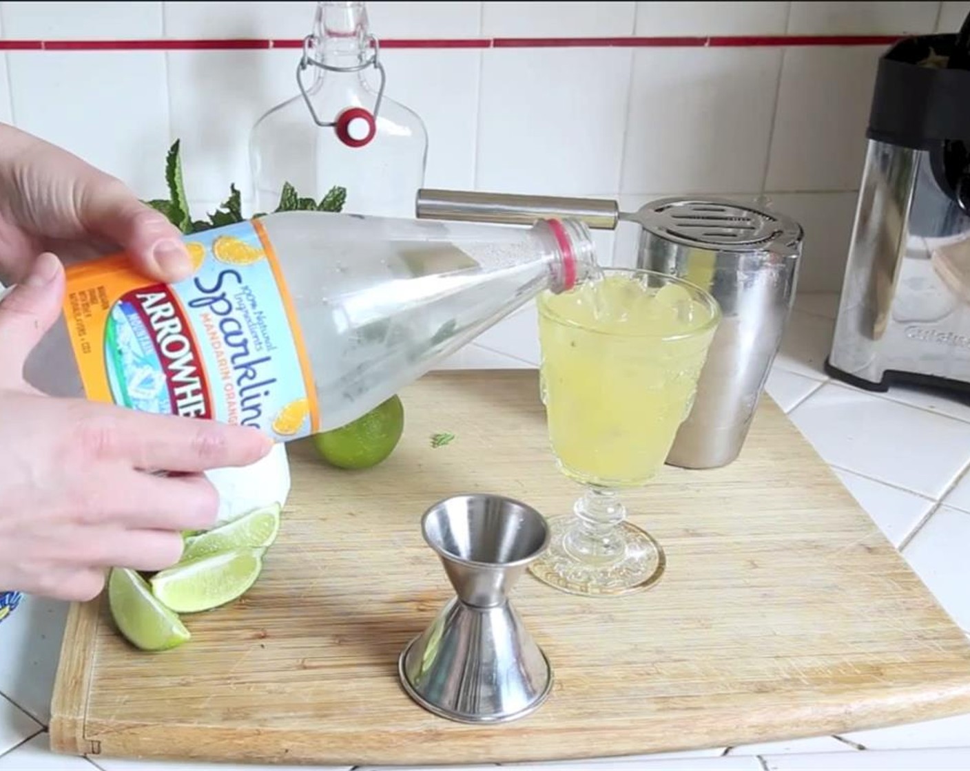 step 8 Strain mojito mixture into a high ball or bucket glass of fresh ice and top with Sparkling Orange Water (to taste).