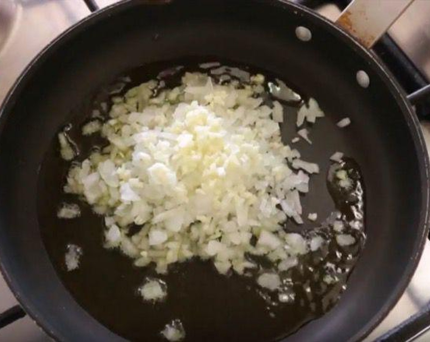 step 6 Add the Garlic (2 cloves) and Onion (1) and mix with the oil. Cook for about 4 minutes.