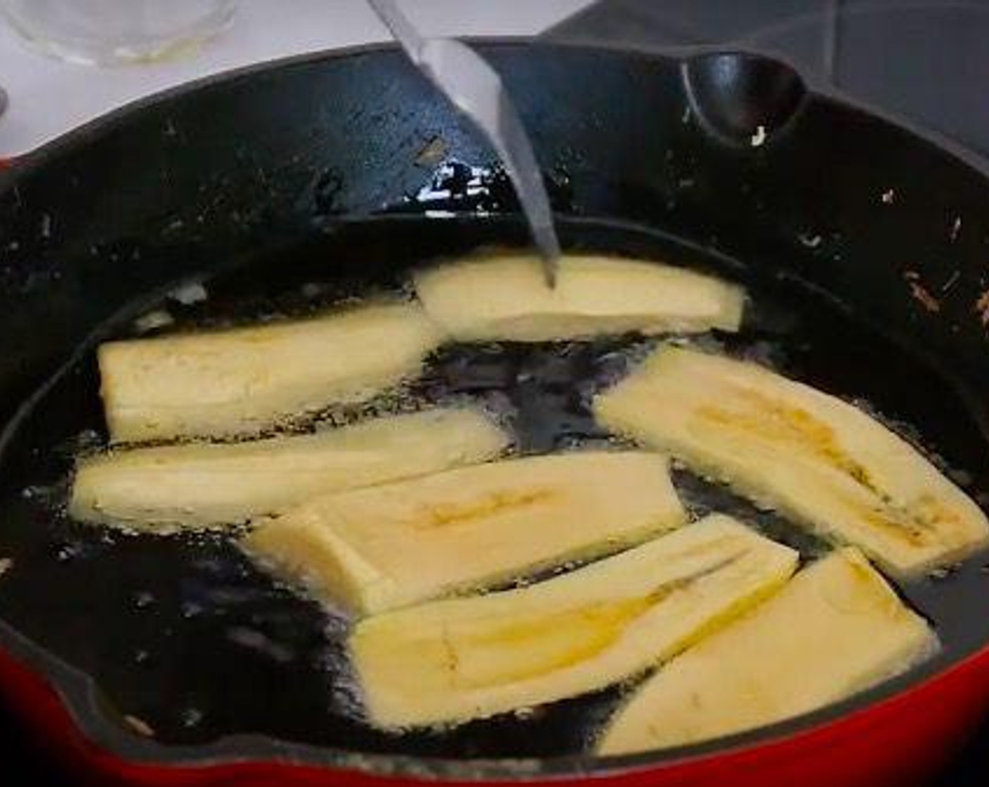 step 6 In the meantime, slice the Plantains (2) and fry in abundant Vegetable Oil (as needed). Place the fried plantain over some kitchen paper to absorb the extra oil.