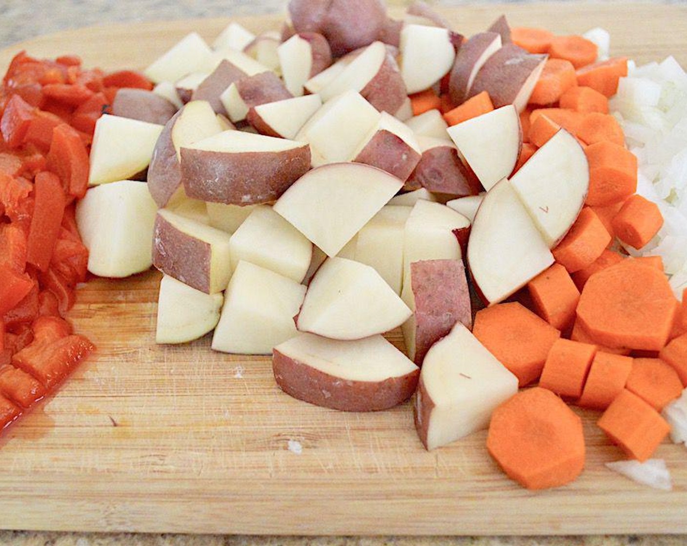 step 2 Add Butter (1 Tbsp) then Garlic (5 cloves), Red Potatoes (4), Carrots (3), Roasted Red Peppers (1 jar), and Onion (1) in it for 6-8 minutes to let them get really soft and fragrant.