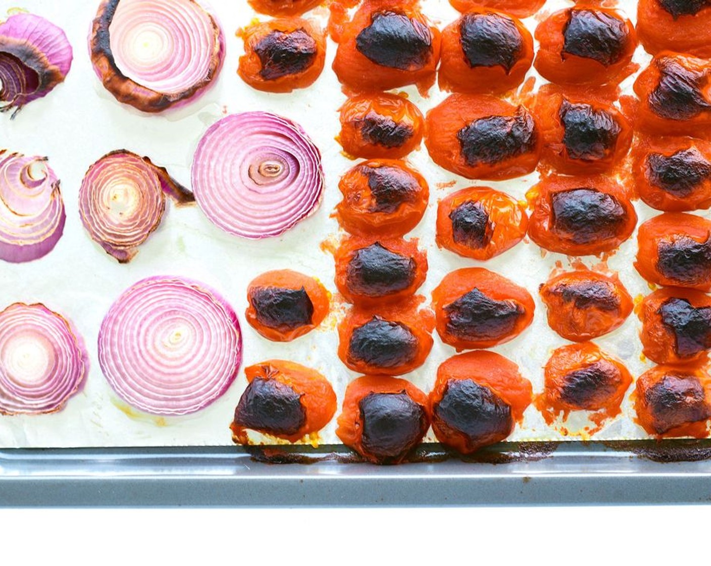 step 2 After about 5 minutes or once the chilies have blackened slightly, open the oven door, slide out the baking tray and use tongs to remove the chilies and set them aside. Slide the tray back in the oven and close the oven door to let the onions and tomatoes continue broiling/grilling for 10 minutes or until the skin of the tomatoes have blackened significantly and the onion slices have charred. Remove the baking tray from the oven and allow the tomatoes and onions to cool for 5-10 minutes.