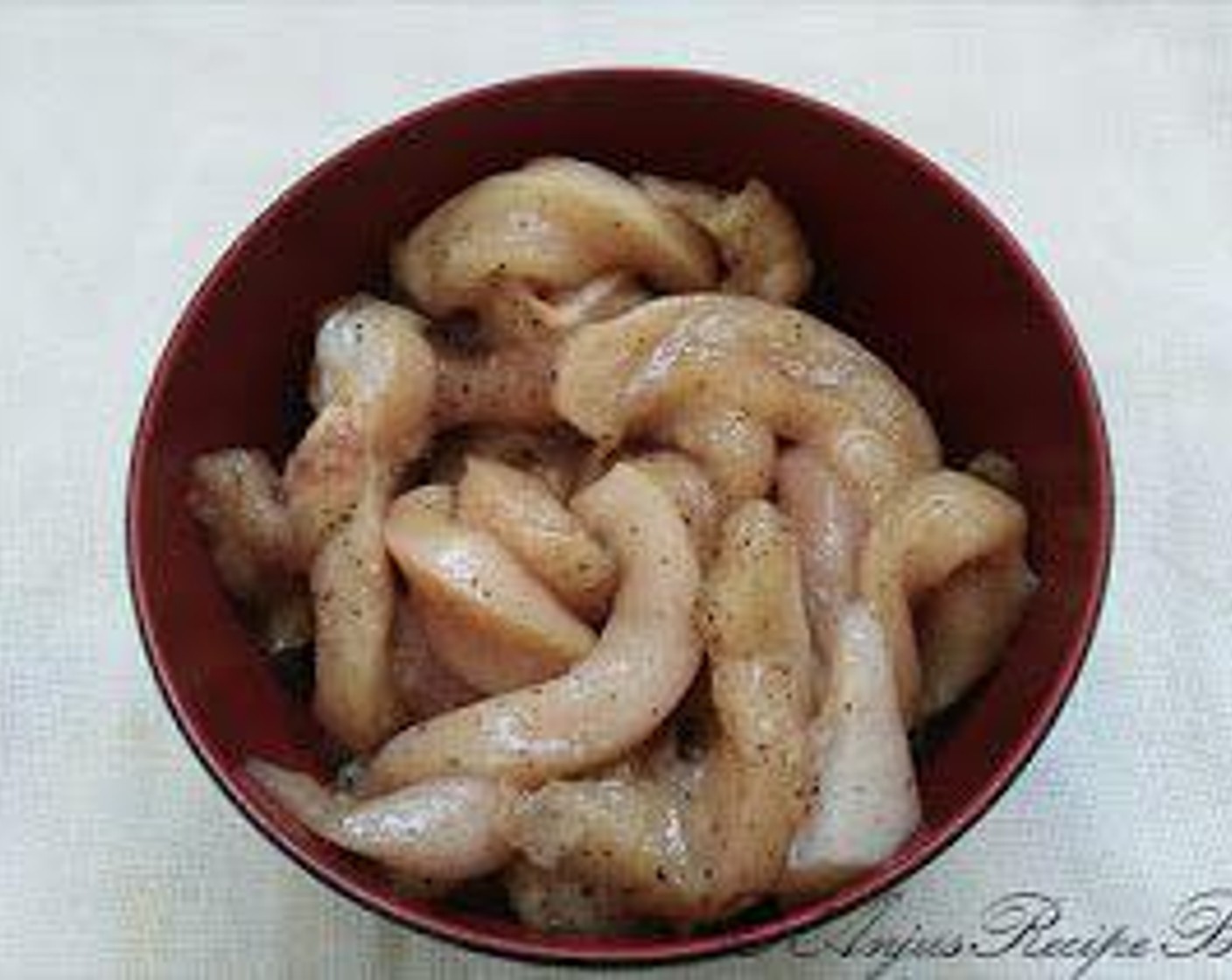 step 1 Cut the Boneless Skinless Chicken (1 cup) to thin strips and marinate it with Ground Black Pepper (1 tsp) and some Salt (to taste) and keep aside.