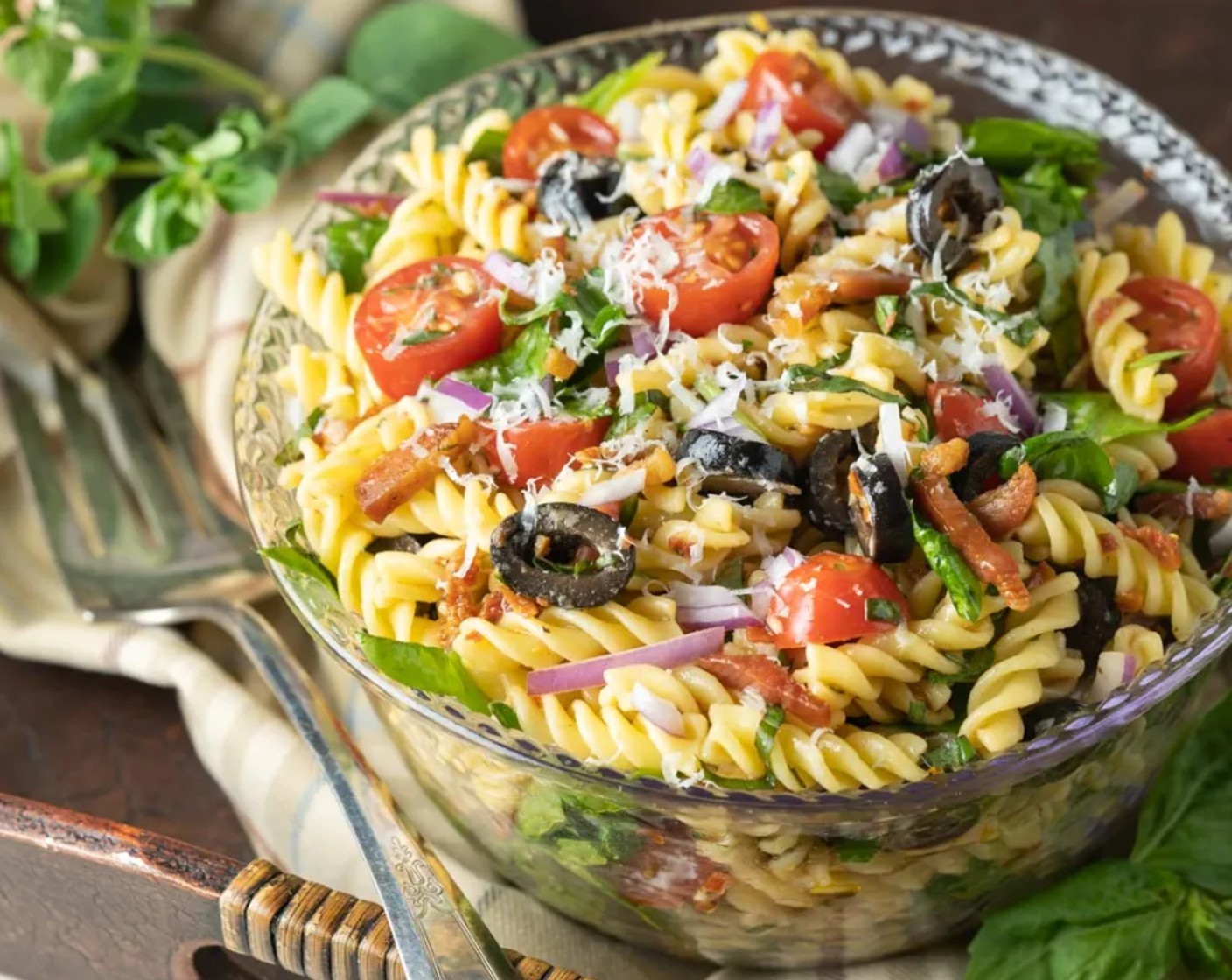 step 4 Toss together pasta, pancetta, Fresh Baby Spinach (2 cups), Cherry Tomato (1 cup), Black Olives (1/2 cup), Red Onion (1/3 cup), Parmesan Cheese (1/3 cup), and dressing until combined. Adjust seasoning and serve.