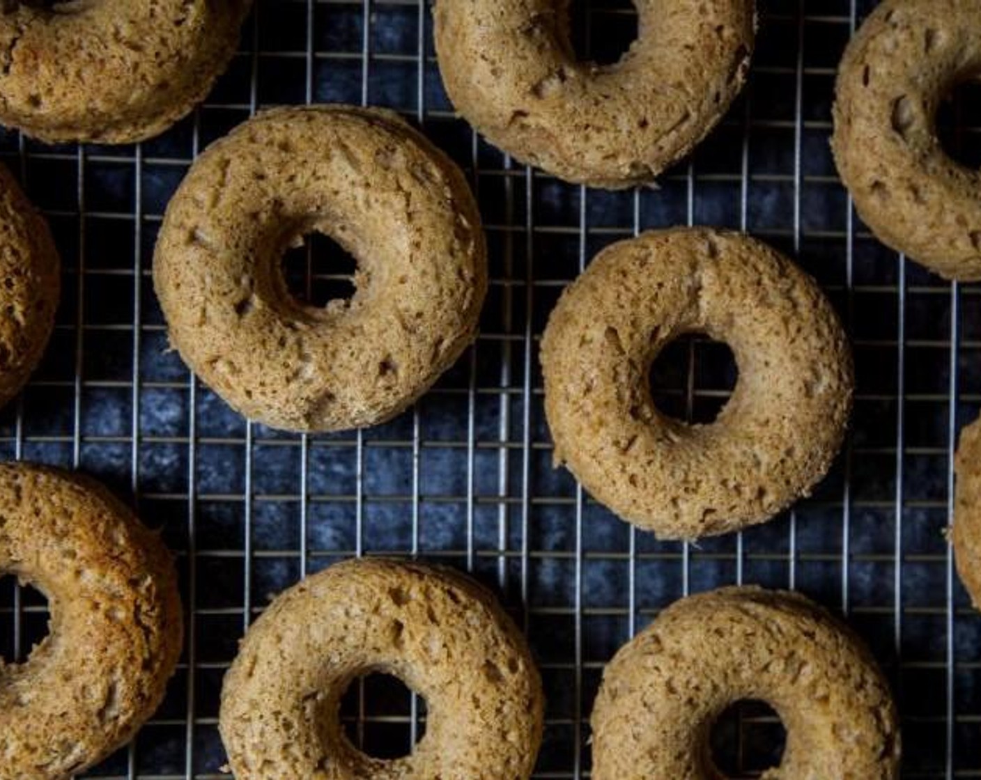 step 5 Spray two 6-cavity doughnut pans with non-stick cooking spray. Spoon the batter into each cavity filling only 3/4 of the way full. Bake the doughnuts for about 10 to 12 minutes or until golden brown. Remove them from the oven and place on a wire rack to cool before glazing.