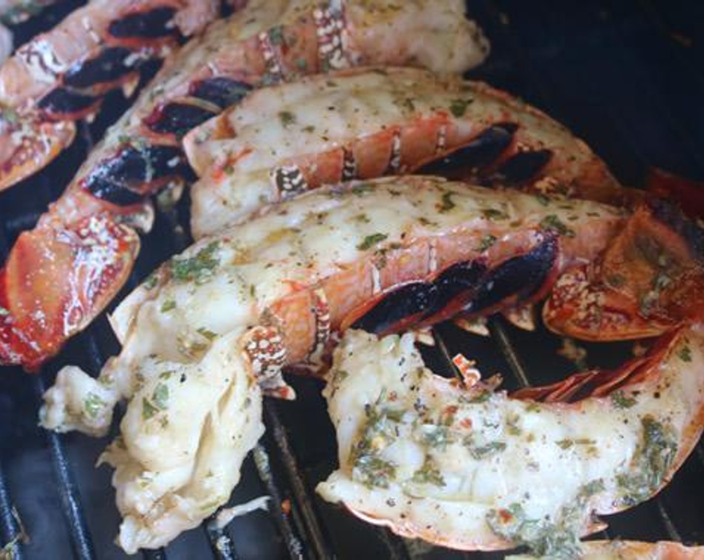 step 6 Dunk each tail in the butter mixture and place shell side down on grill. Baste meat again with butter mixture.