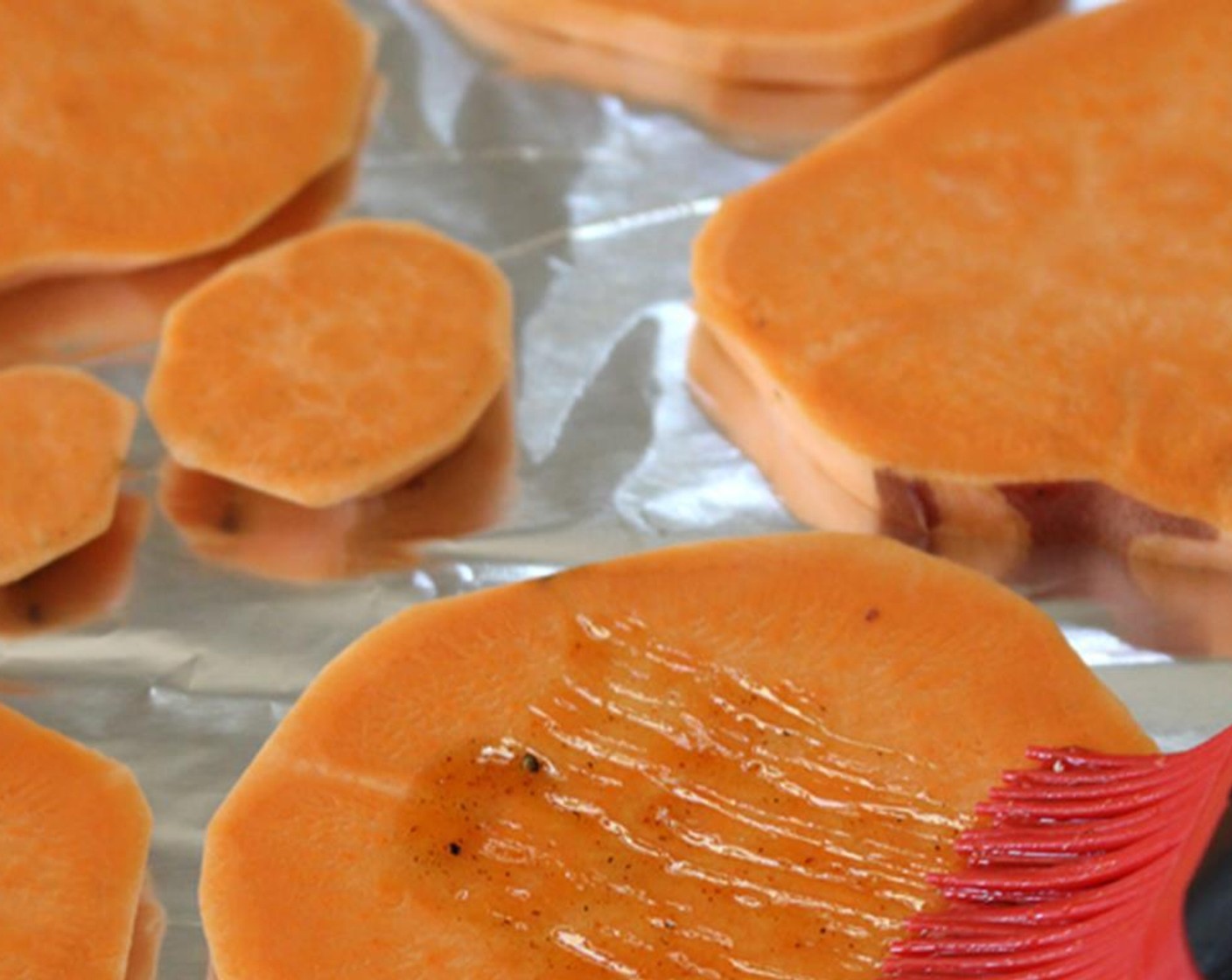 step 5 Place the sweet potato slices onto the baking sheet and brush with the mixture.