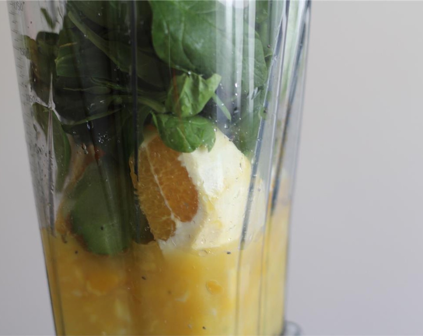 step 1 Pour the Coconut Water (1 cup) into the blender. Add the Frozen Pineapple (1/2 cup), Frozen Mangoes (1/2 cup), Orange (1), Kiwifruit (1), Fresh Spinach (1 cup), and Chia Seeds (2 Tbsp).