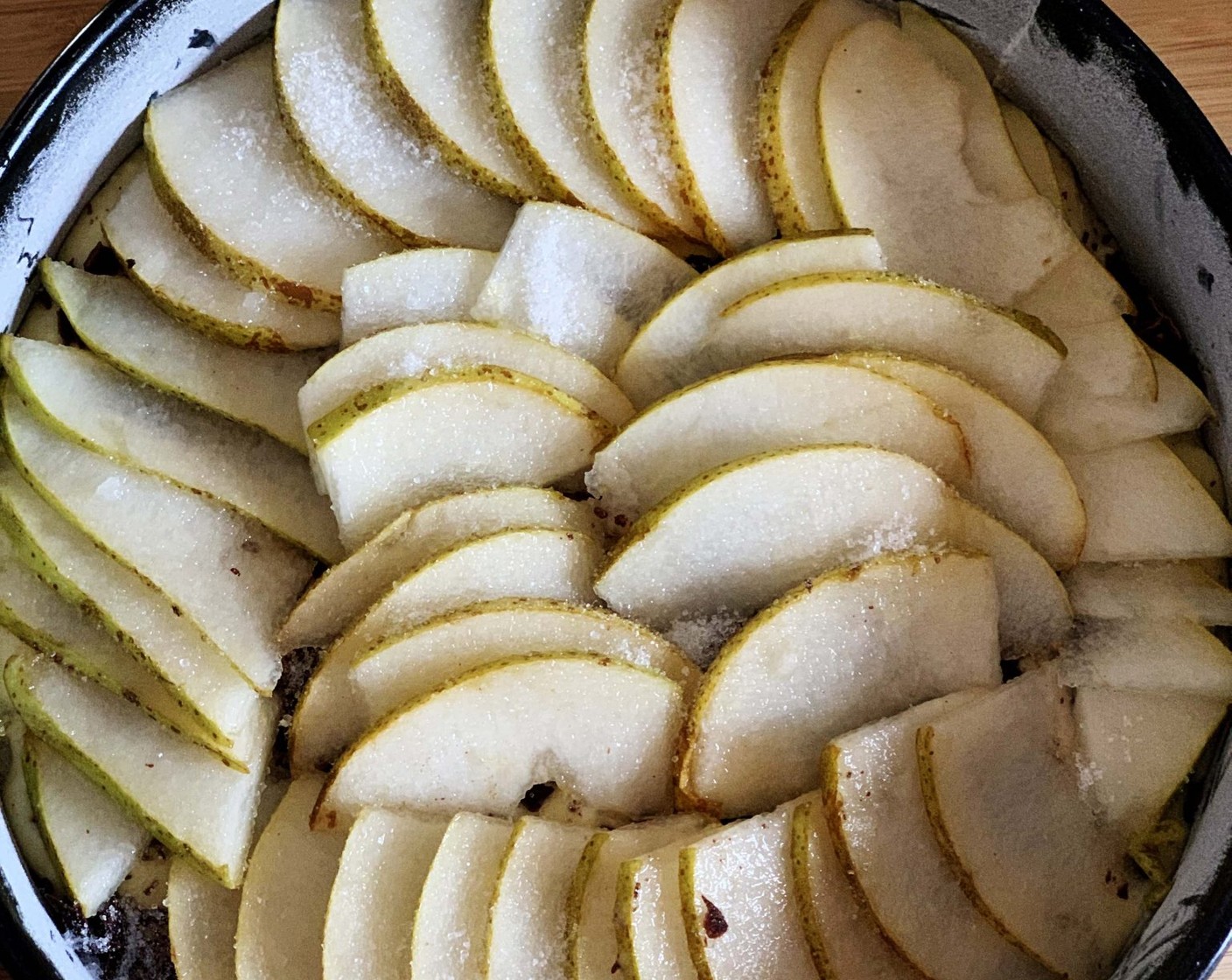 step 6 Pour the batter in an 8-inch pan lined with parchment paper. Cover the top with Dark Chocolate (3 1/2 Tbsp) and with the second sliced pear. Sprinkle some Erythritol sugar on top.