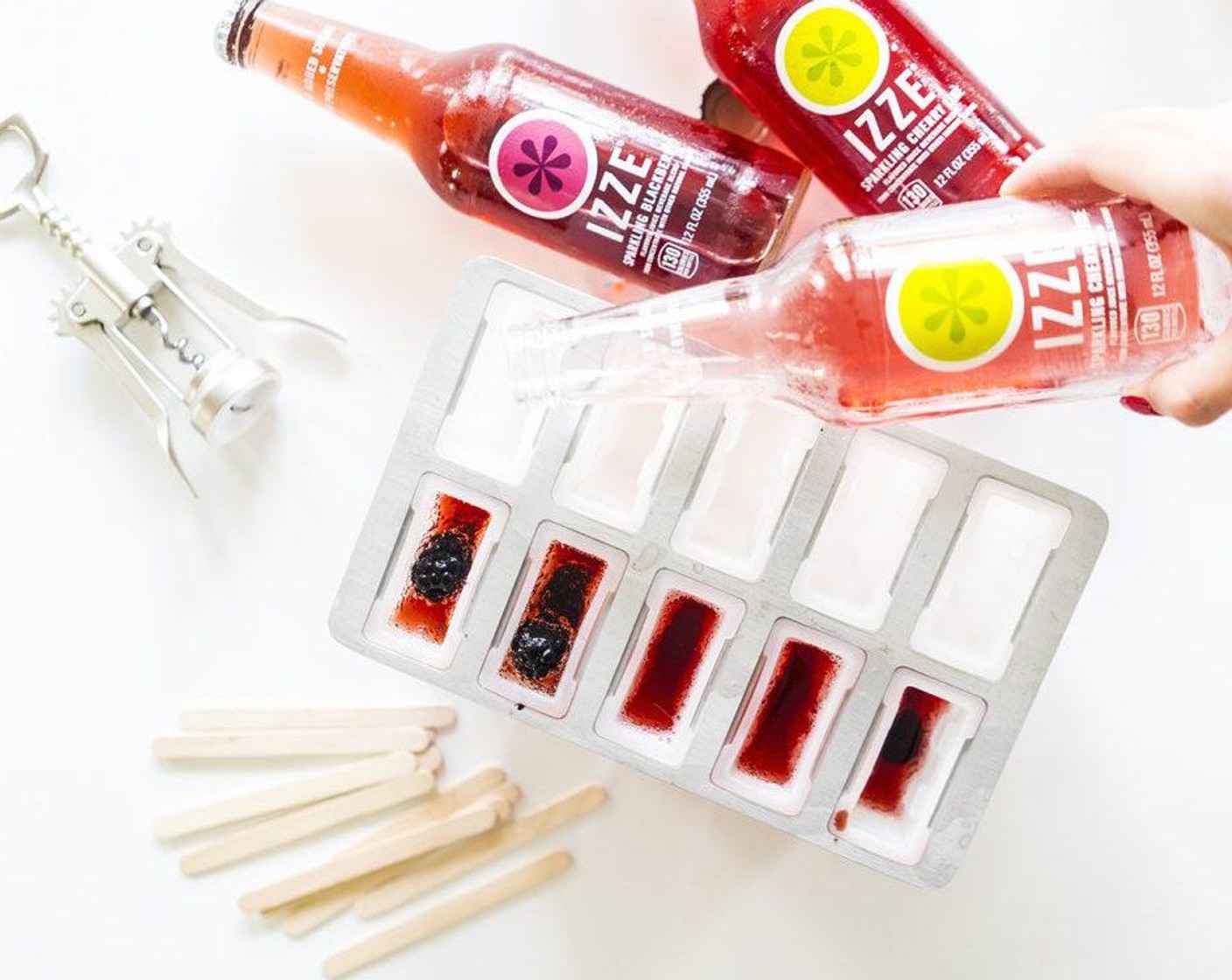 step 1 Fill your ice pop molds with IZZE® Sparkling Juice Blackberry (12 fl oz) and IZZE® Sparkling Juice Cherry Lime (12 fl oz) in separate compartments. Pour about 60 percent into each mold, because the liquid is going to expand as it freezes.