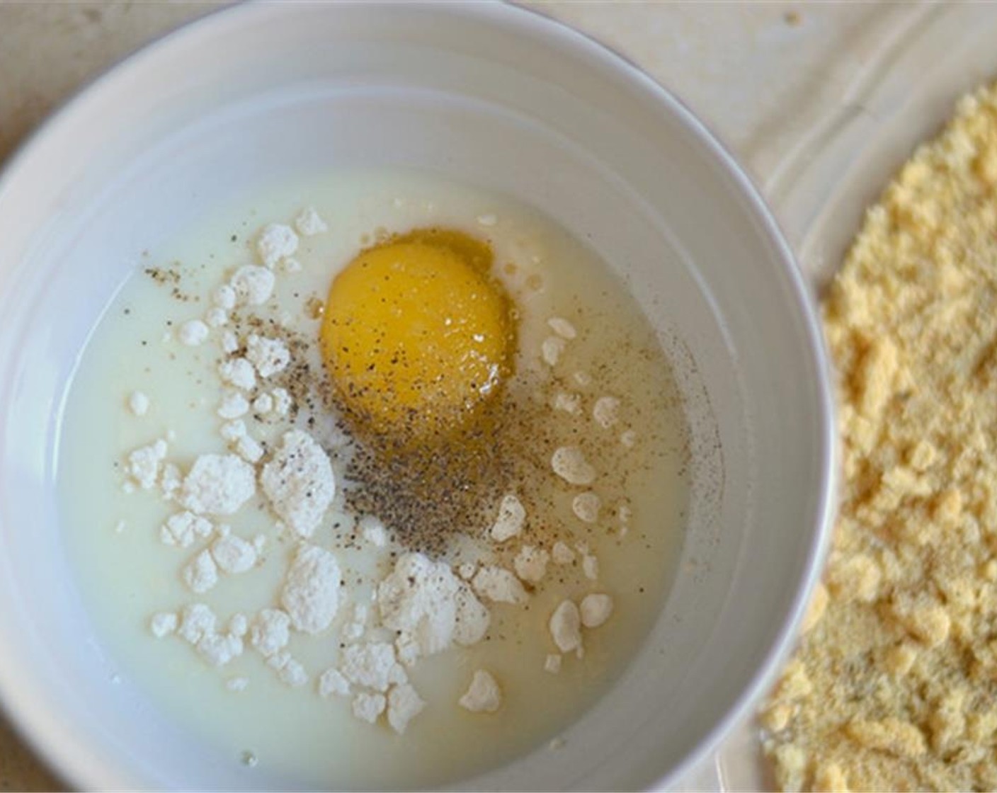 step 4 Put the Milk (3/4 cup), All-Purpose Flour (1 Tbsp), and Egg (1) in a bowl. Add some spices to this too if you like.