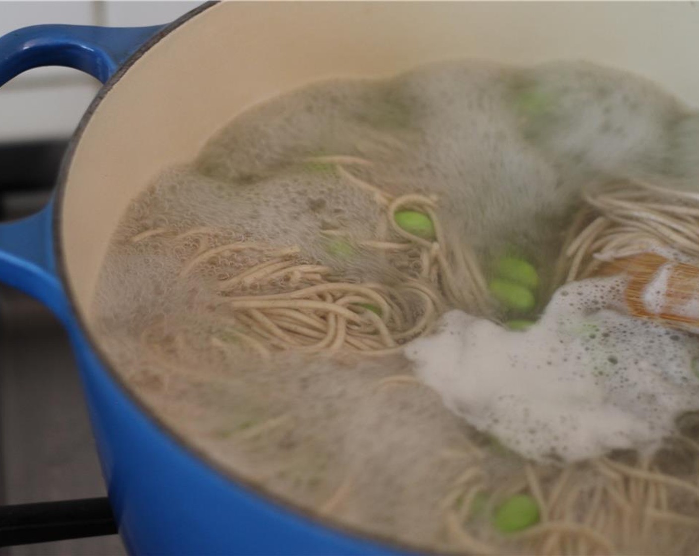 step 13 Bring a pot of water to a boil. Cook the Soba Noodles (1 pckg) by following the instructions on the package. Cook the Edamame (100 g) with the Soba Noodles (1 package) - they can be cooked together at the same time!