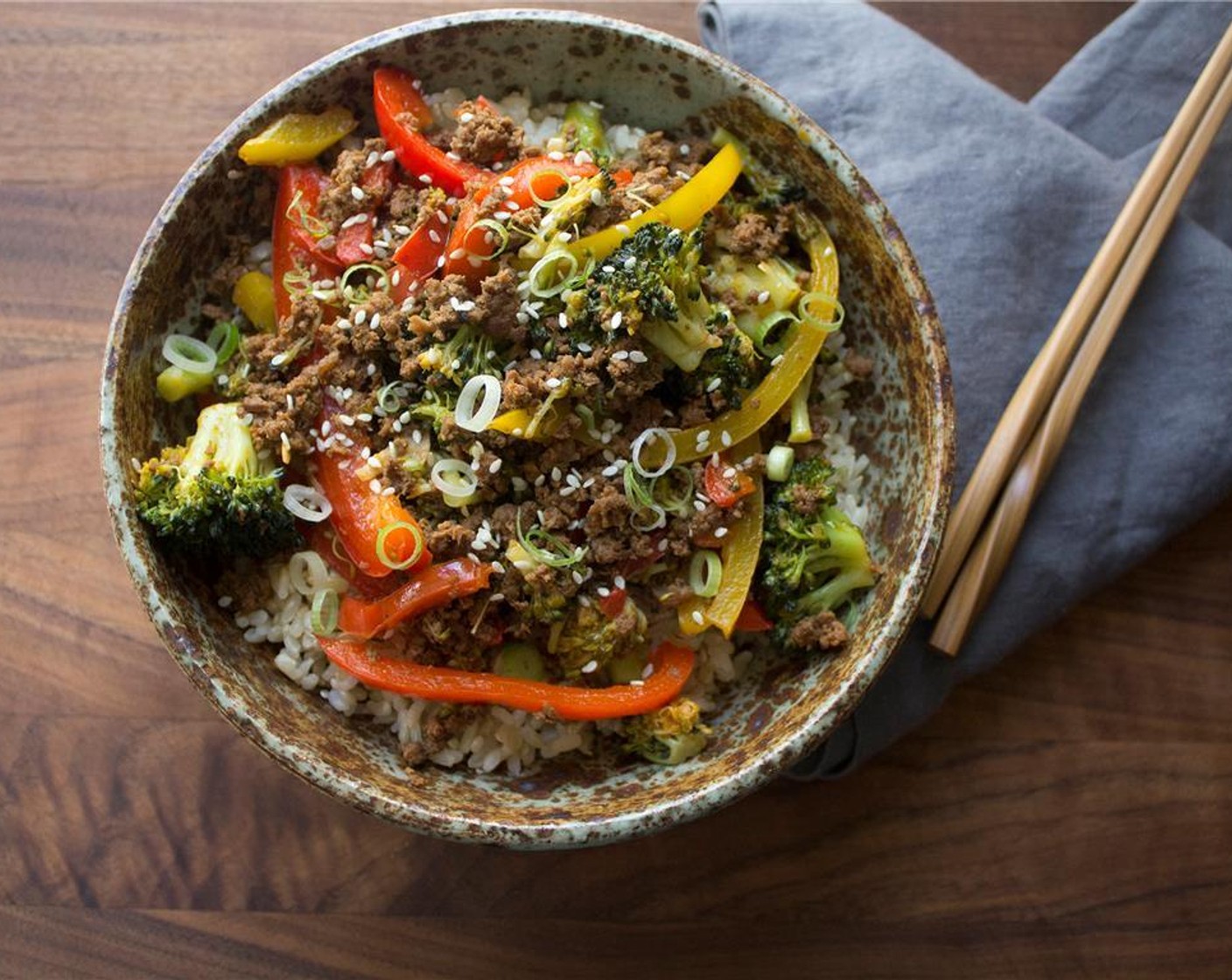 step 7 Put cooked brown rice in a bowl, top with beef and veggie mixture. Sprinkle with Sesame Seeds (to taste) and sliced scallions. Enjoy!
