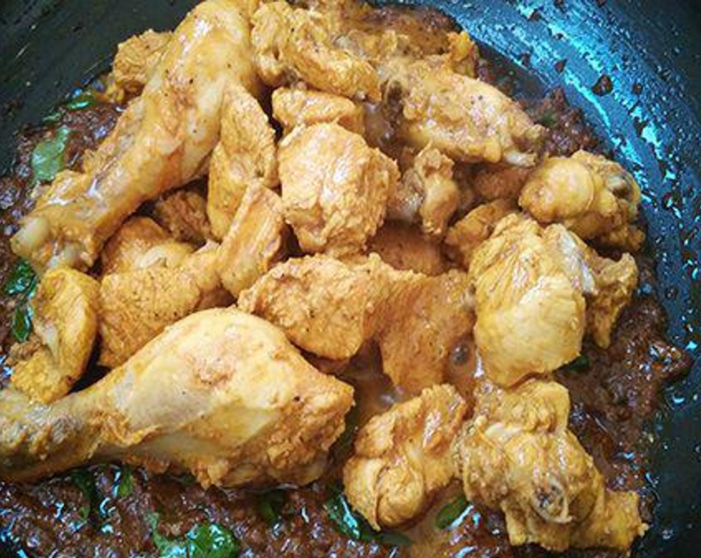 step 4 To a pan add marinated chicken and cover and cook in low flame.  Do not add water. To a pan pour Ghee (1/3 cup) and once it is heated well add the masala paste. Saute until oil starts to leave.  Add Curry Leaves (3 sprigs). Add the cooked chicken and cover and cook for some more time.